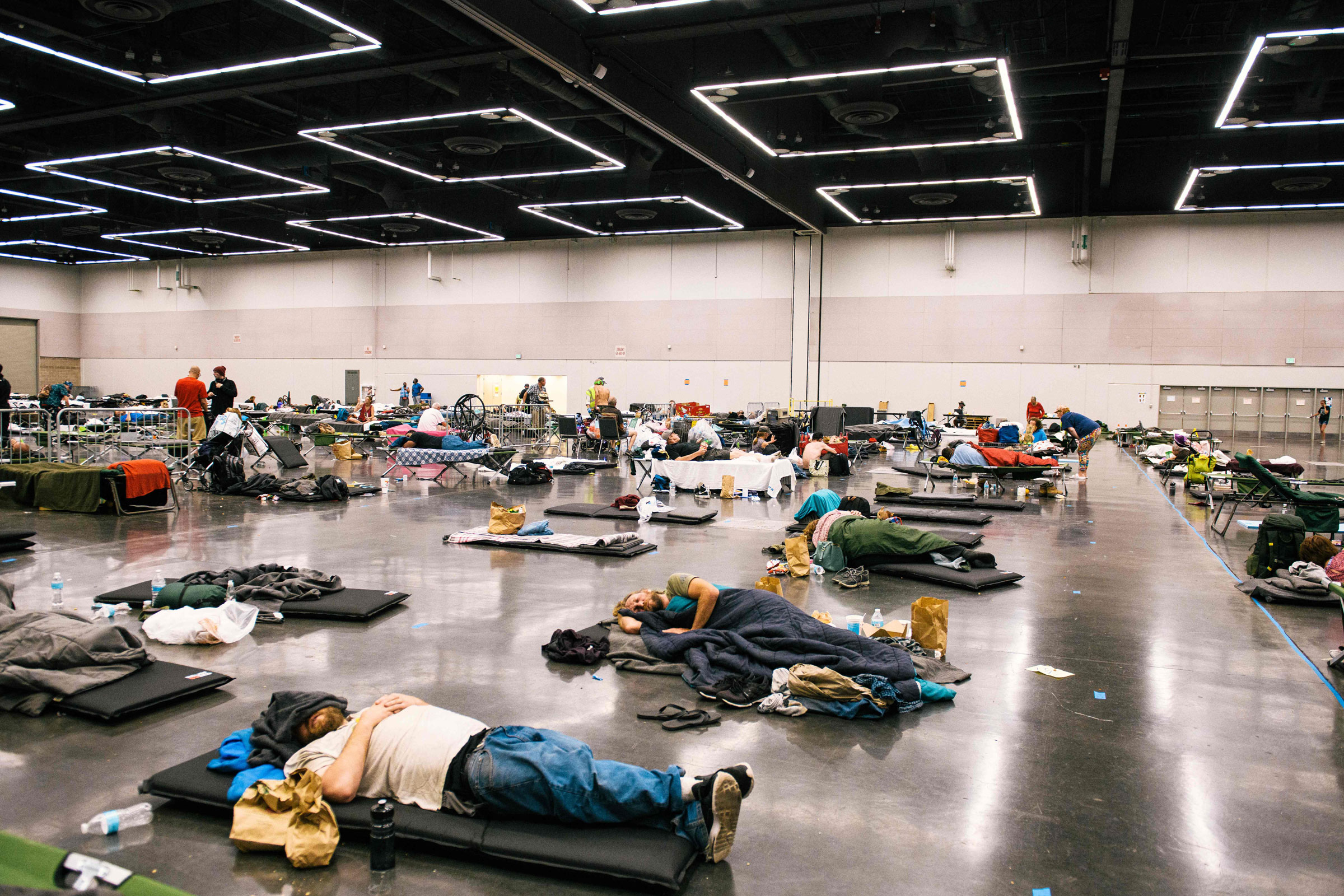 People rest at the Oregon Convention Center cooling station in Portland, Ore., on June 28, 2021, as a heatwave moves over much of the United States. (Kathryn Elsesser—AFP/Getty Images)