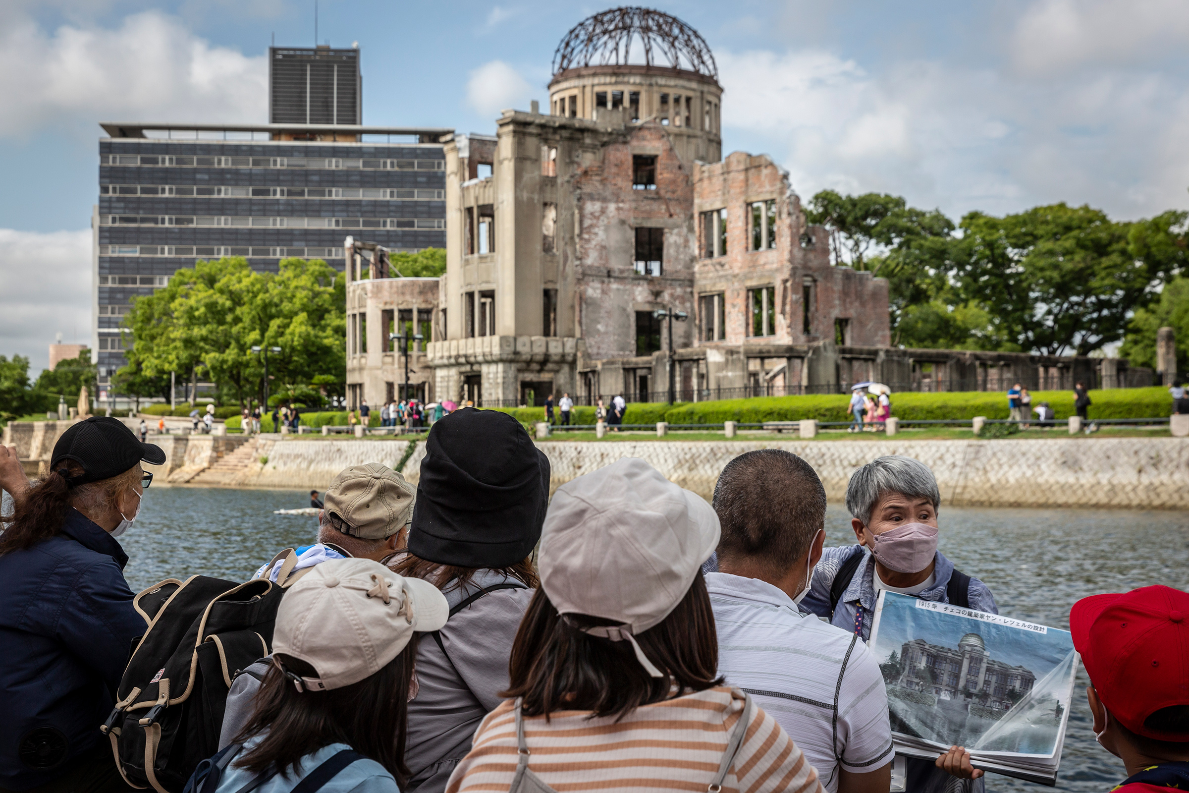 A volunteer guide explains the history of the Atomic Bomb Dome in Hiroshima’s Peace Memorial Park on Aug. 05, 2022. (Yuichi Yamazaki—Getty Images)