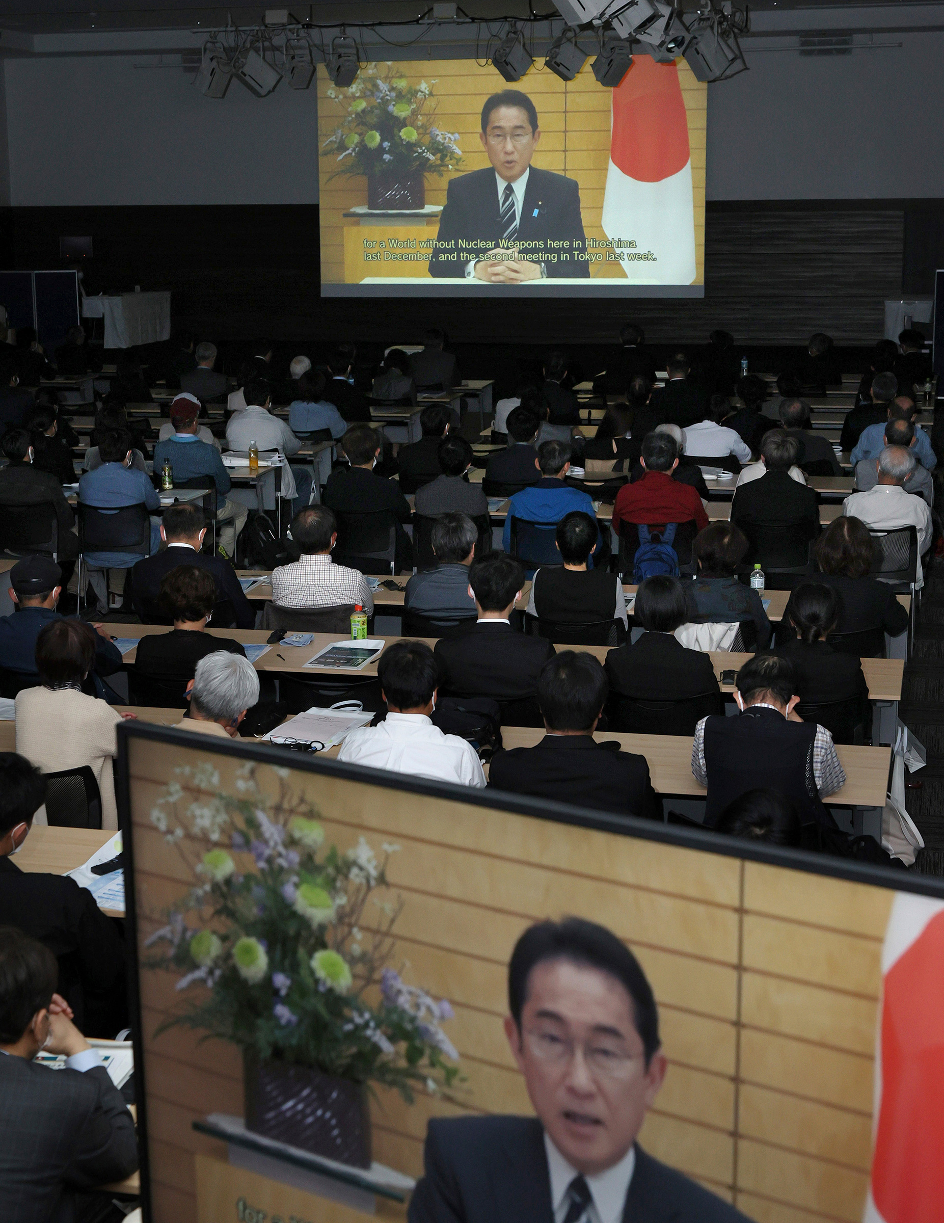 Japanese Prime Minister Fumio Kishida delivers a video message during the G7 Summit Commemorative Symposium at the Hiroshima Convention Hall on April 15. (The Yomiuri Shimbun/AP)