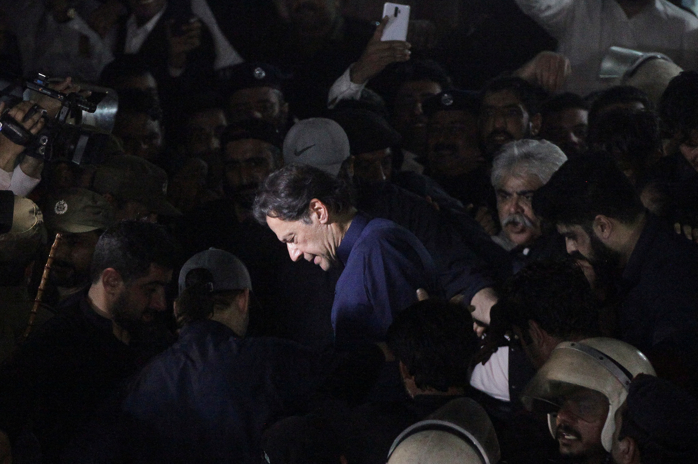 Khan, surrounded by supporters, leaves the district High Court in Lahore on Feb. 20. (Mohsin Raza—Reuters)
