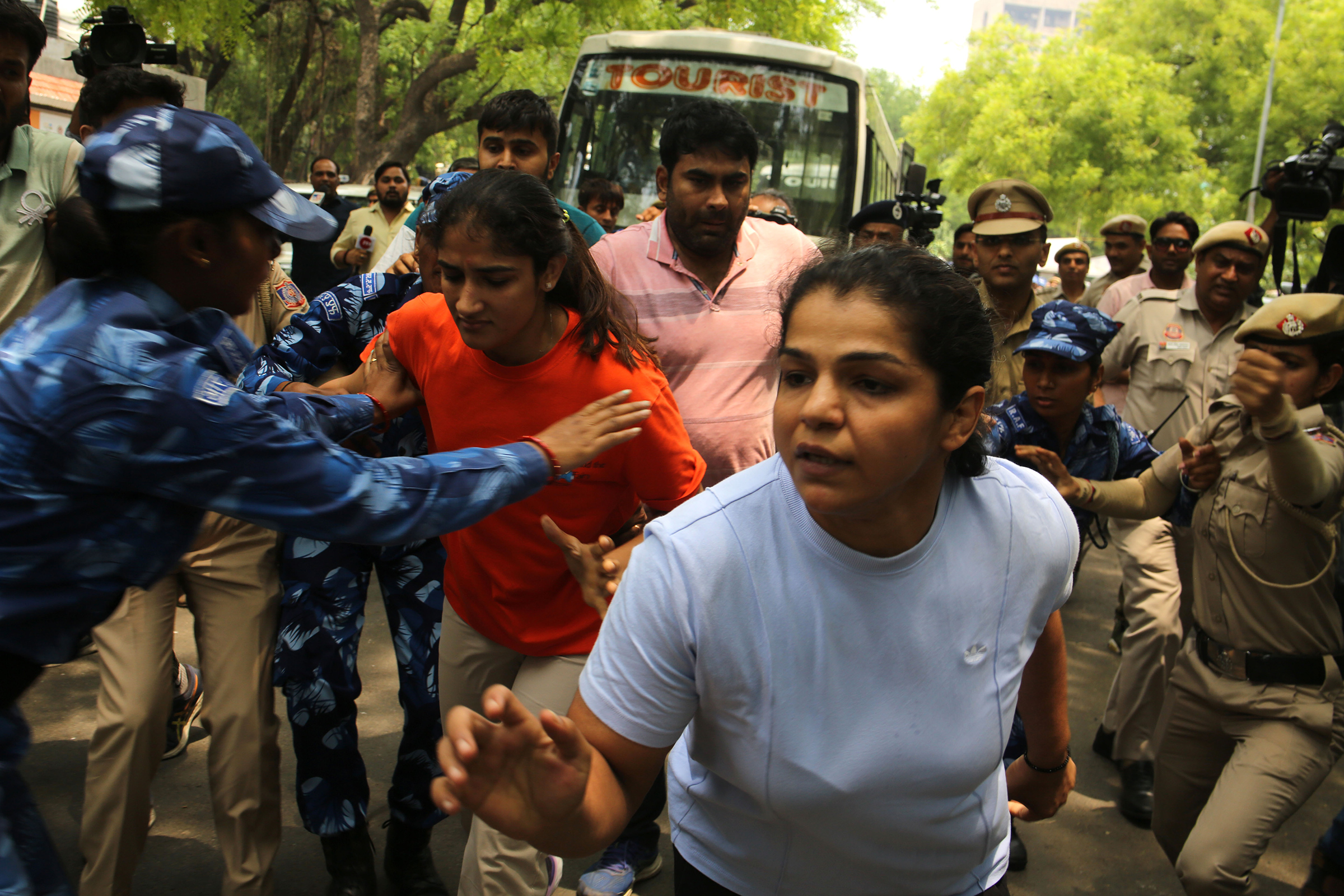 Wrestlers Sakshi Malik, Vinesh Phogat, and Bajrang Punia, along with supporters march toward India's parliament on May 28. (Salman Ali—Hindustan Times/Getty Images)