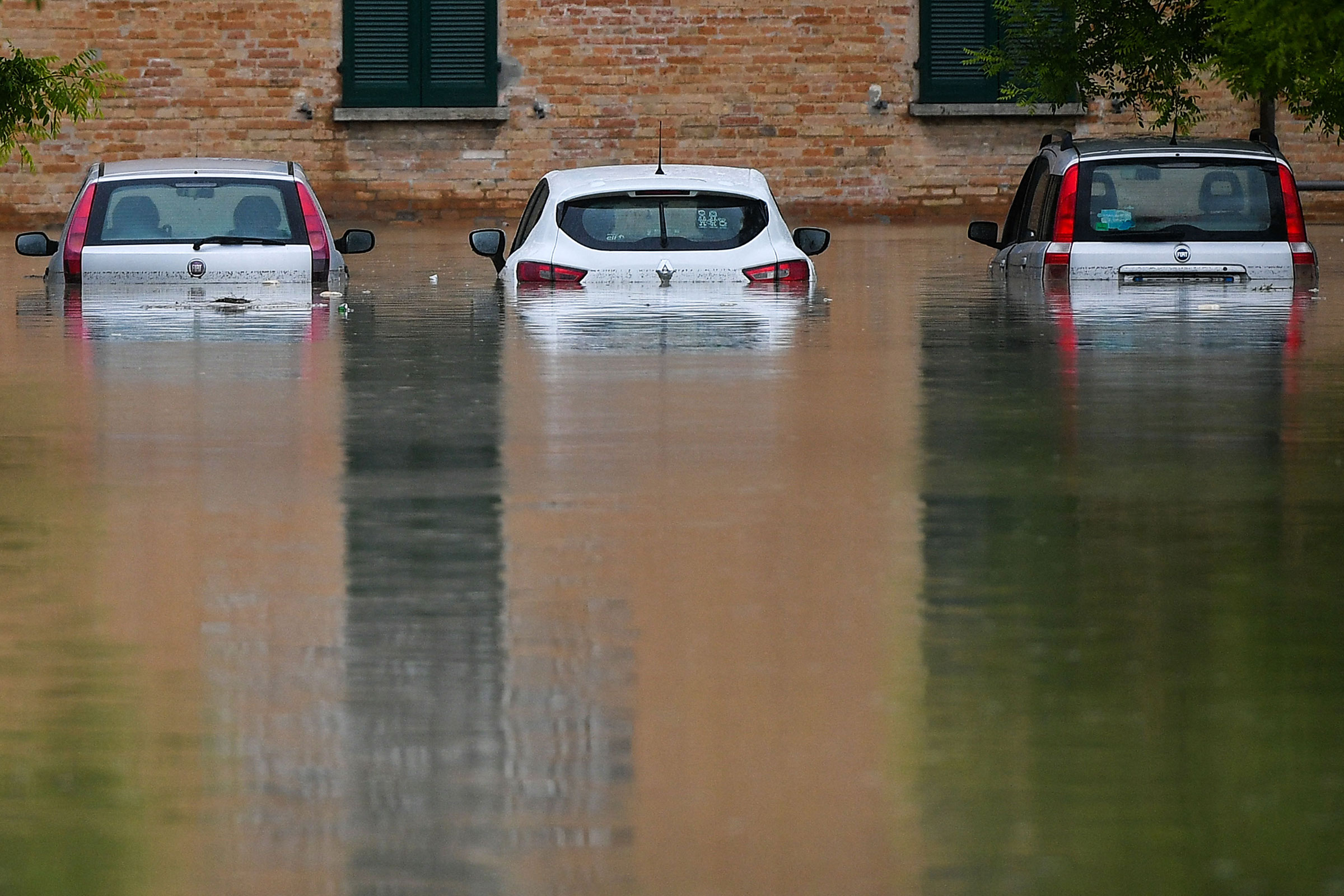 Flooded cars are pictured in a street of Cesena on May 17.
