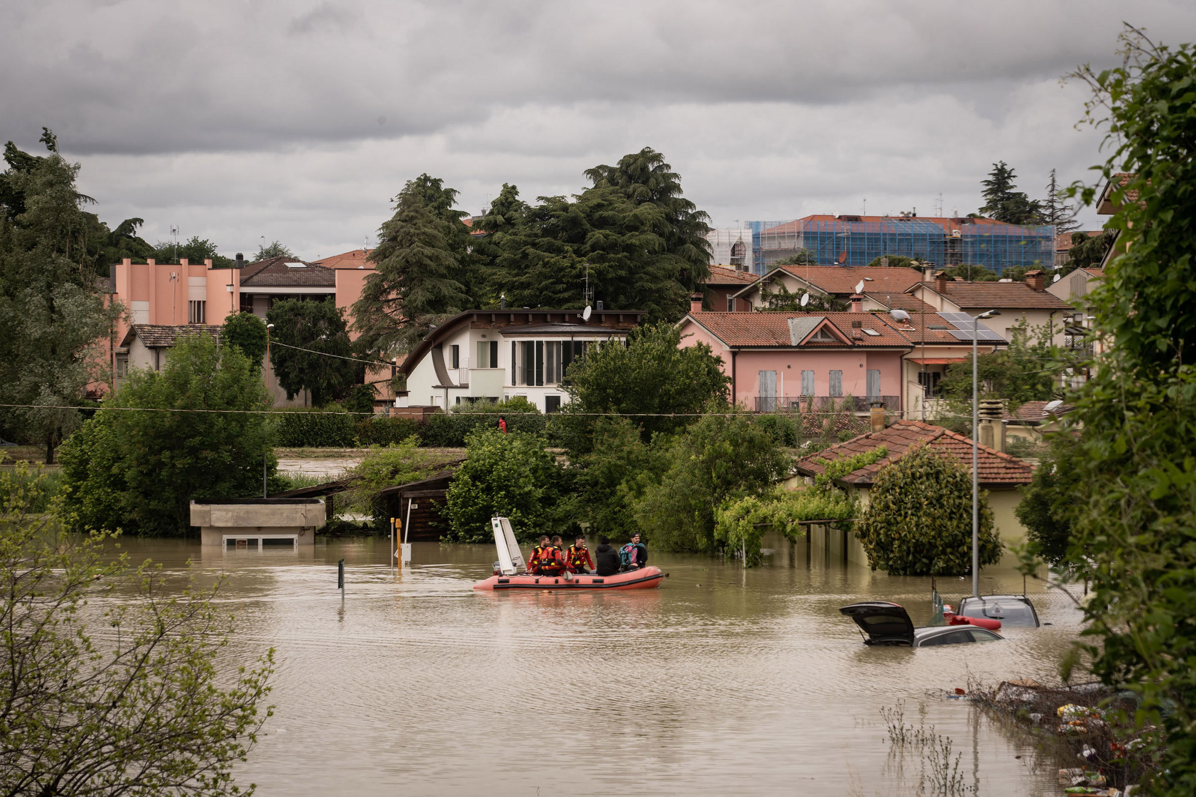 Rescue workrs help residents during the flooding in Cesena on May 17.