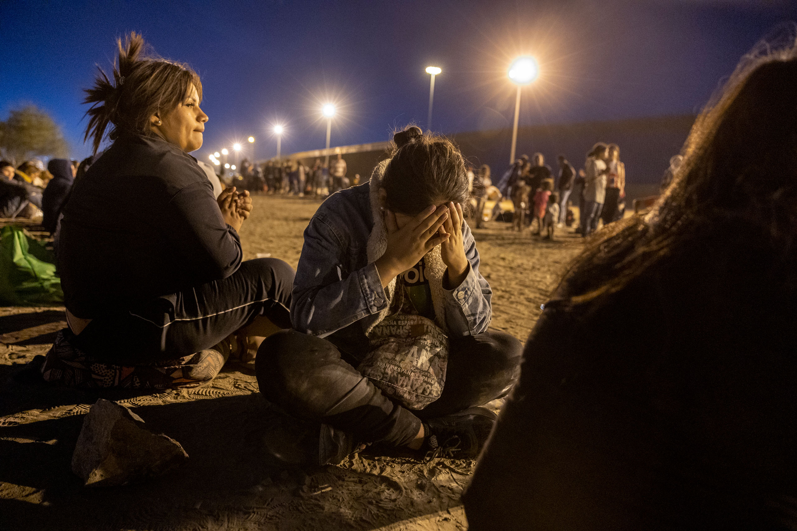 Immigrants seeking asylum in the United States wait to be processed by U.S. border agents after crossing over from Mexico into El Paso, Texas, on May 9, 2023. (John Moore—Getty Images)