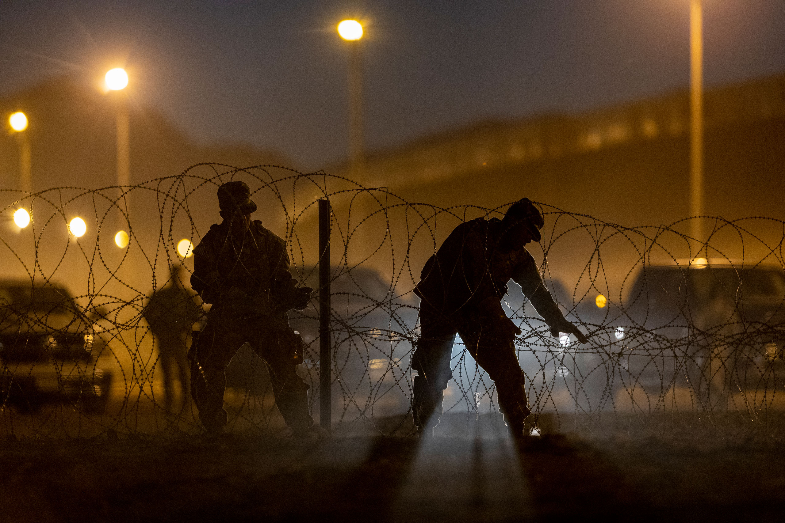 Texas National Guard troops set up razor wire near hundreds of immigrants who had crossed into the United States from Mexico on May 9, 2023. (John Moore—Getty Images)