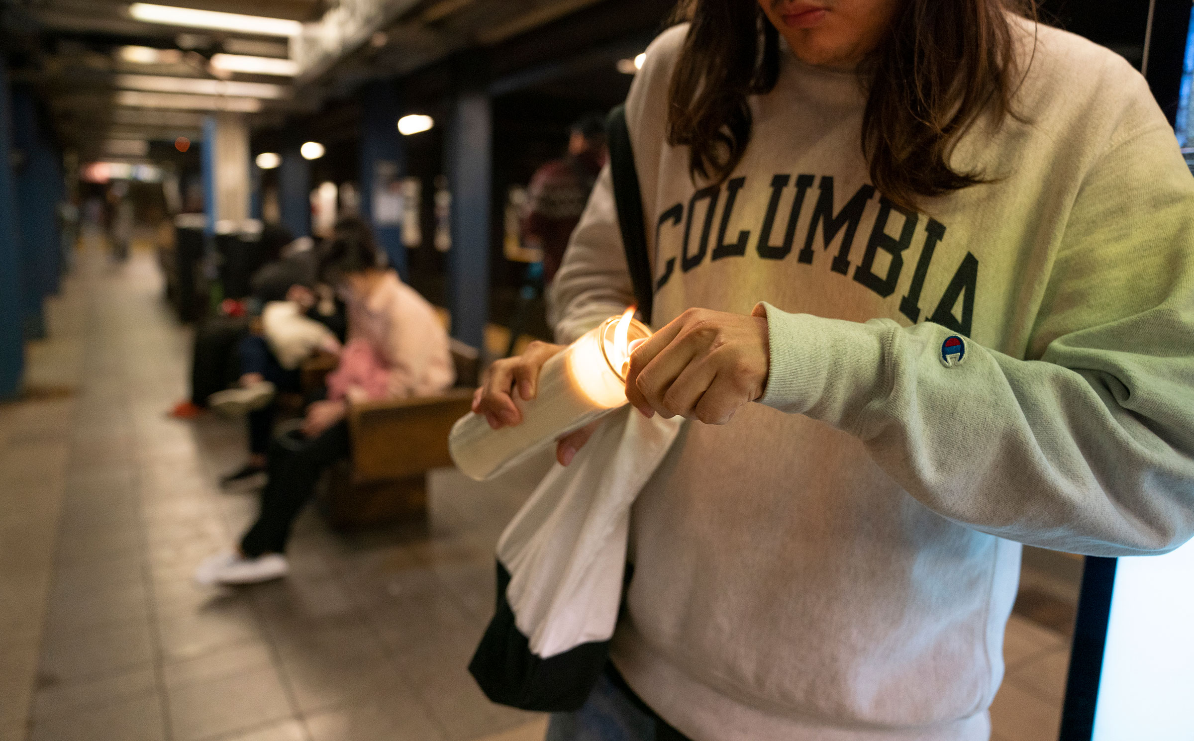 A vigil participant lights a candle in memory of Jordan Neely in the Broadway-Lafayette subway station in Manhattan, on May, 3, 2023.