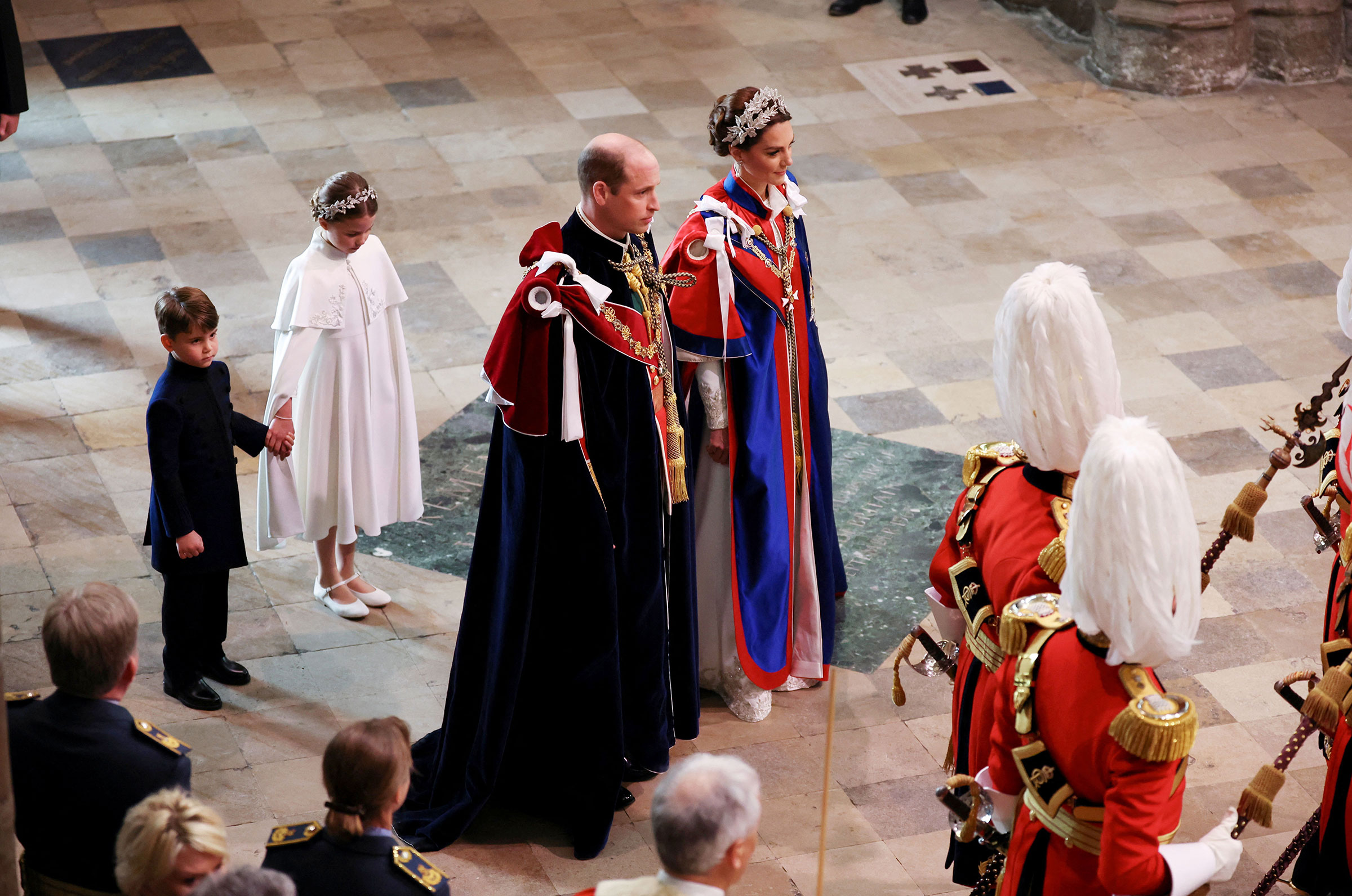 Prince William and Catherine, Princess of Wales, followed by their children Prince Louis and Princess Charlotte, arrive for the Coronation of King Charles III and Queen Camilla. (Phil Noble—WPA Pool/Getty Images)