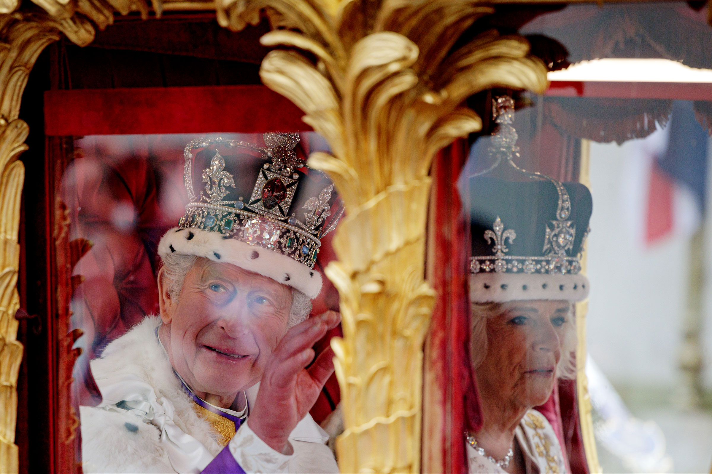 King Charles III and Queen Camilla travel in the Gold State Coach from Westminster Abbey on route to Buckingham Palace following the Coronation of King Charles III and Queen Camilla. (Rob Pinney—Getty Images)