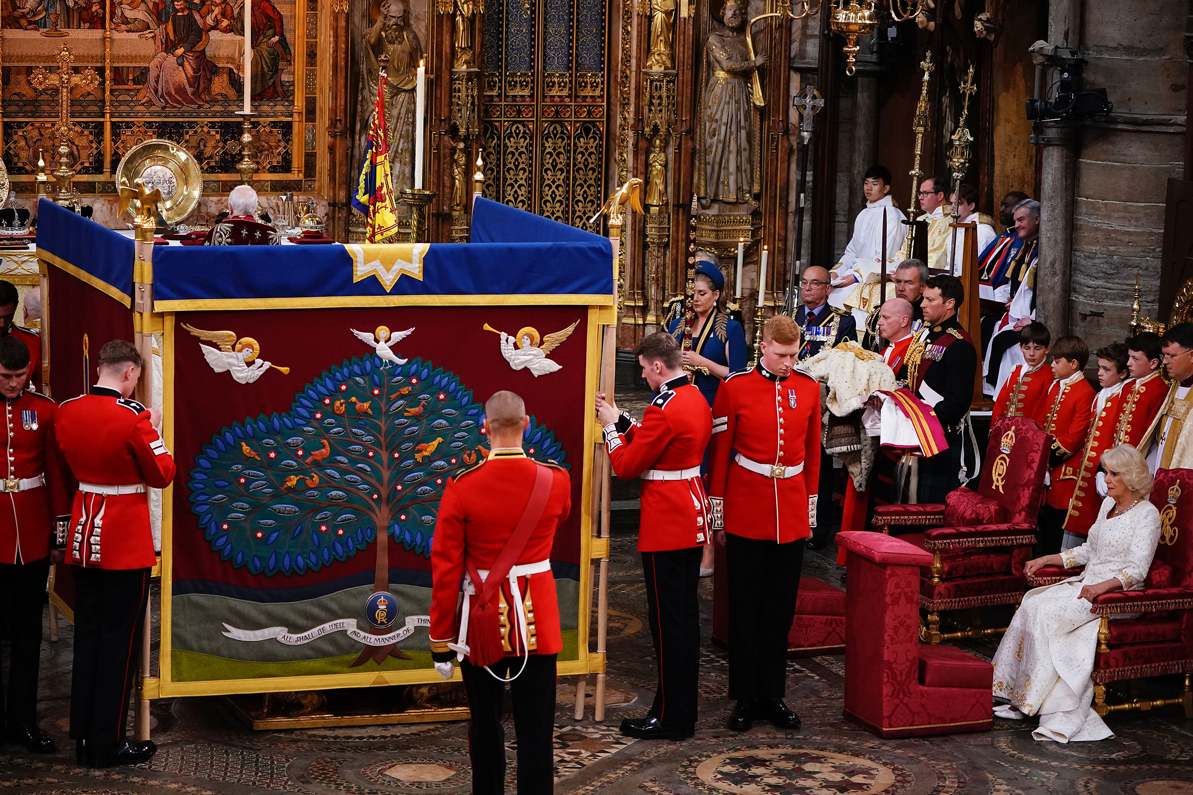 Queen Camilla (right) watches as King Charles III is behind an anointing screen during their coronation ceremony. (Yui Mok—WPA Pool/Getty Images)