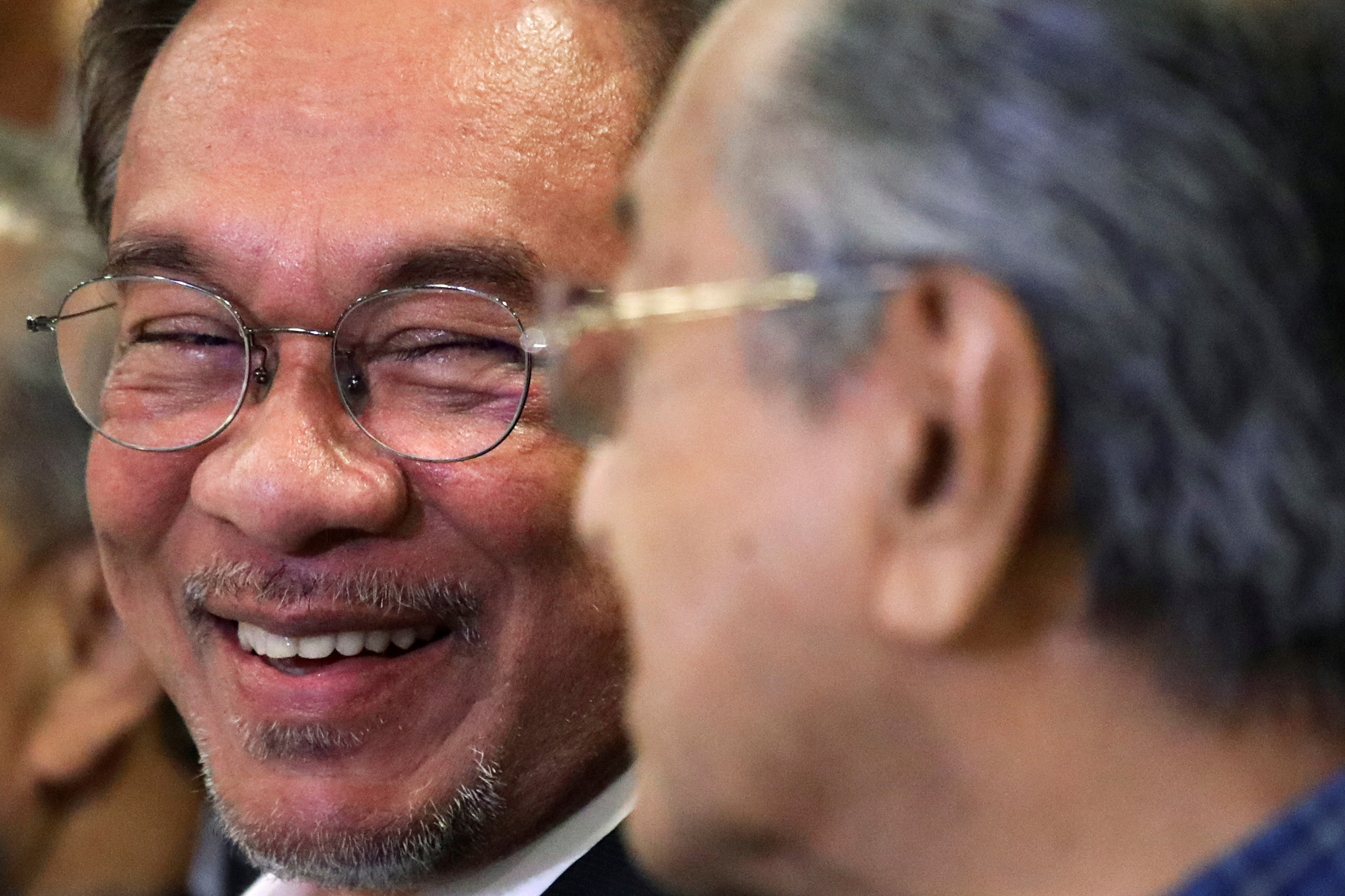 Malaysian politician Anwar Ibrahim looks at former Prime Minister Mahathir Mohamad during a news conference in Putrajaya, Malaysia, Nov. 23, 2019. (Lim Huey Teng—Reuters)