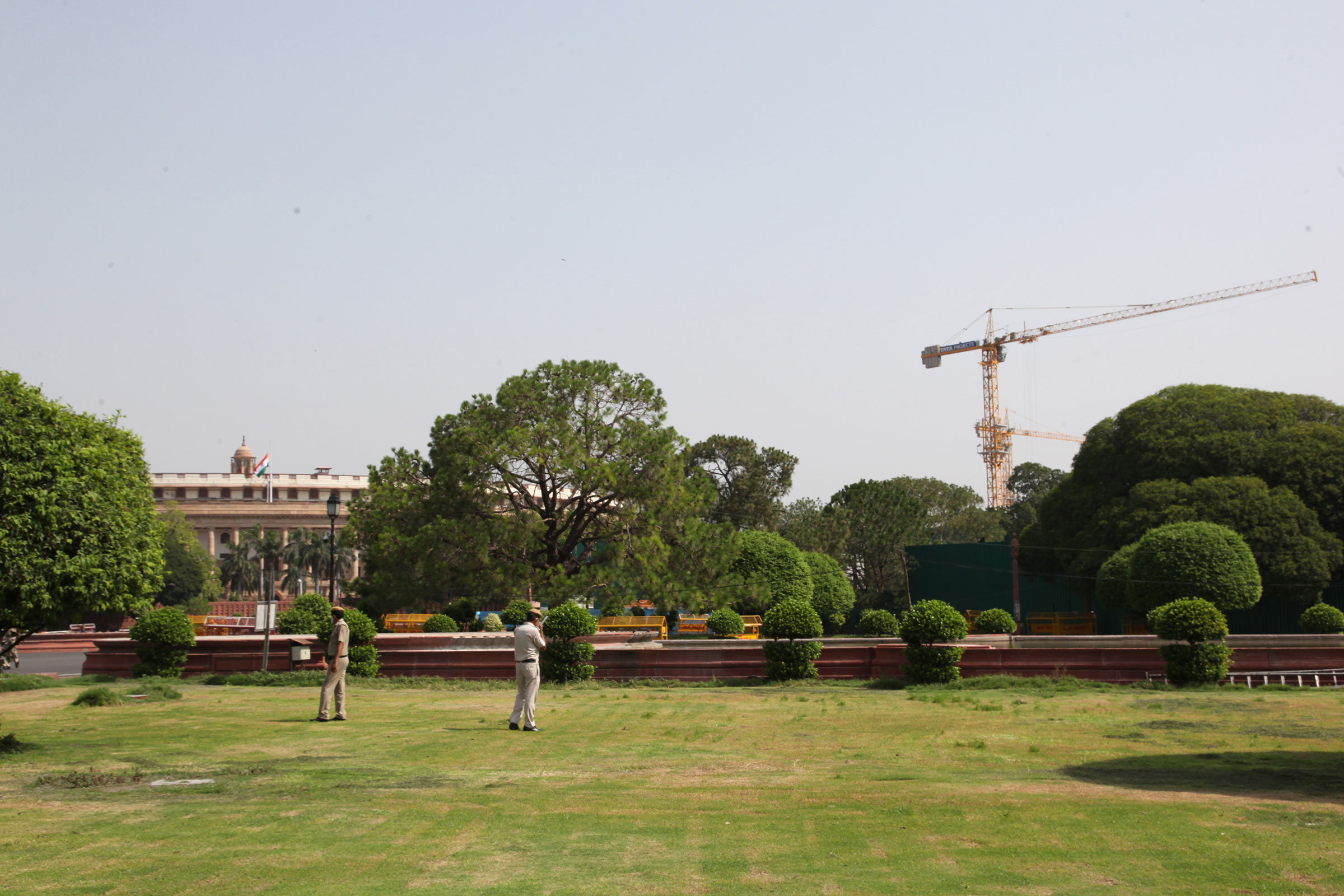 The round heritage building of the Indian Parliament can be seen with massive cranes for the construction of the new Parliament building on June 5, 2021. (Pallava Bagla—Corbis/Getty Images)