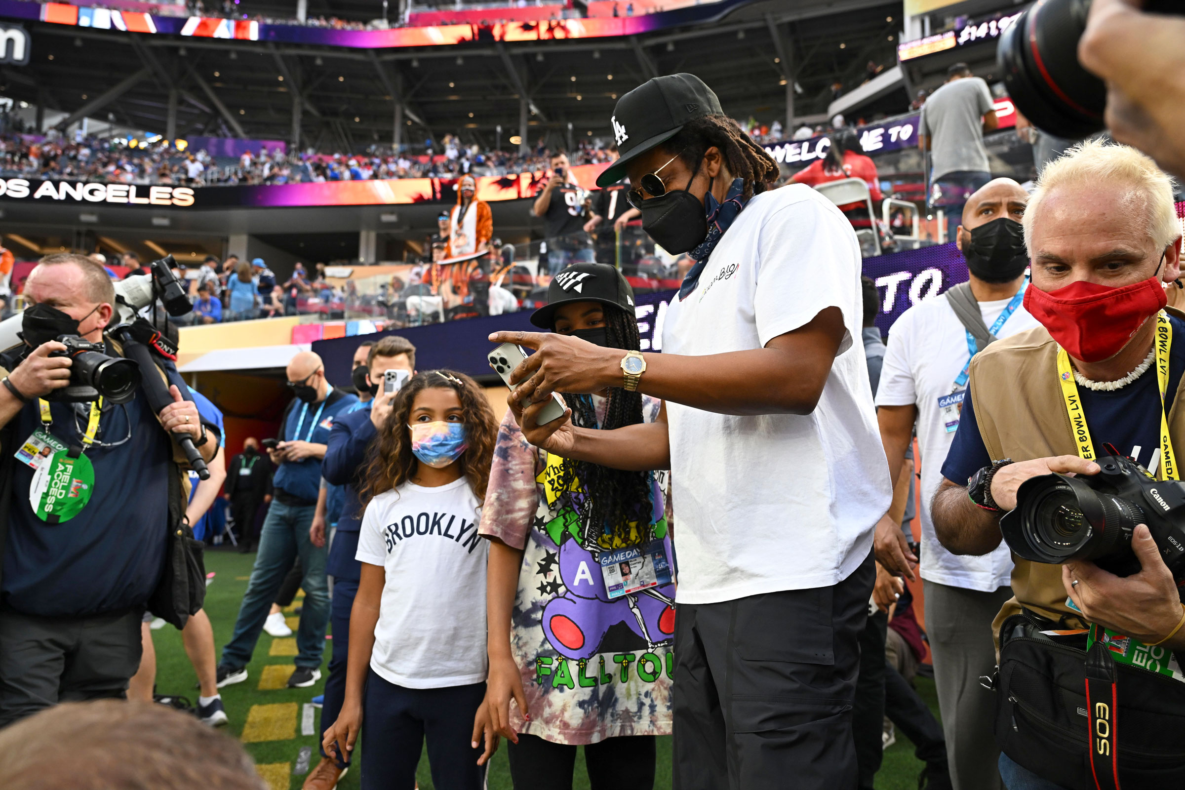 Rapper Jay-Z holding his phone on the sidelines before a Los Angeles Rams vs Cincinnati Bengals game at SoFi Stadium in Inglewood, Calif., on Feb 13, 2022.