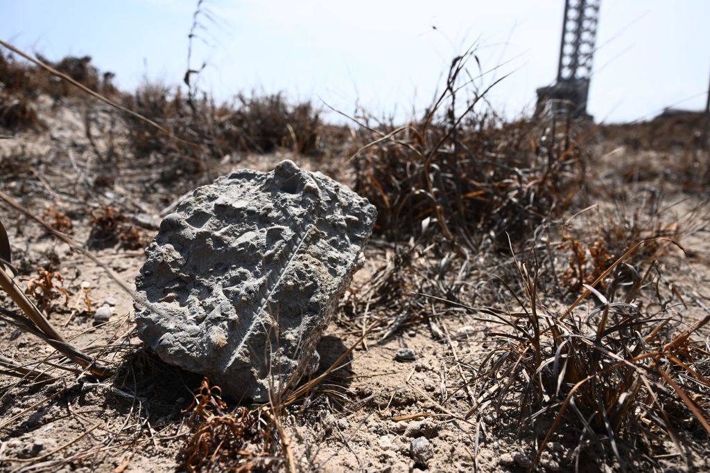 A piece of concrete blown off the launch pad litters the ground on April 22, 2023, after the SpaceX Starship lifted off on April 20 for a flight test from Starbase in Boca Chica, Texas.