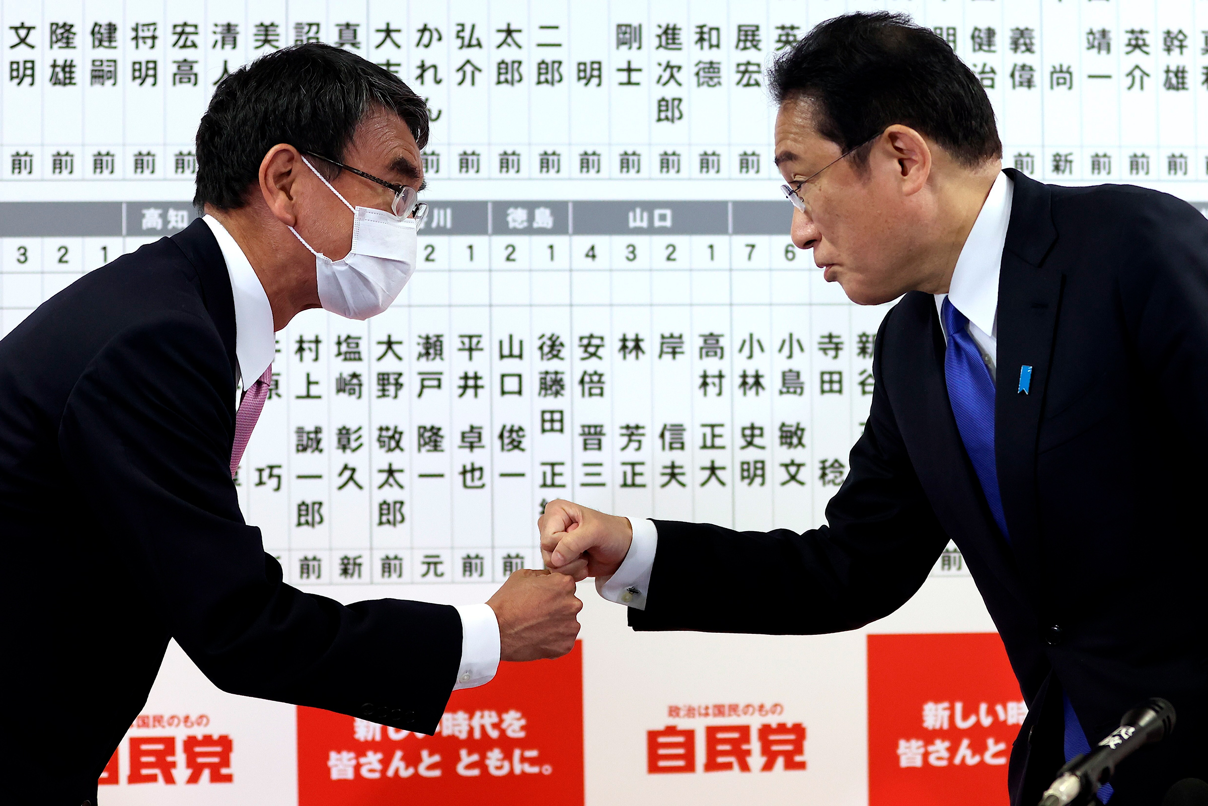Japan Prime Minister Fumio Kishida, right, fist bumps with Kono at the Liberal Democratic Party party headquarters in Tokyo, Oct. 31, 2021. (Behrouz Mehri—Pool/AP)