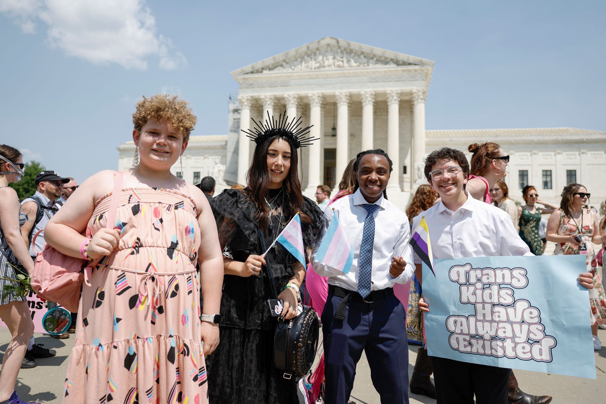 Grayson McFerrin, 12, Libby Gonzales, 13, Hobbes Chukumba, 16, and Daniel Trujillo, 15, the organizers of the “Trans Youth Prom” pose for a photo in front of the U.S. Supreme Court Building in Washington, D.C.