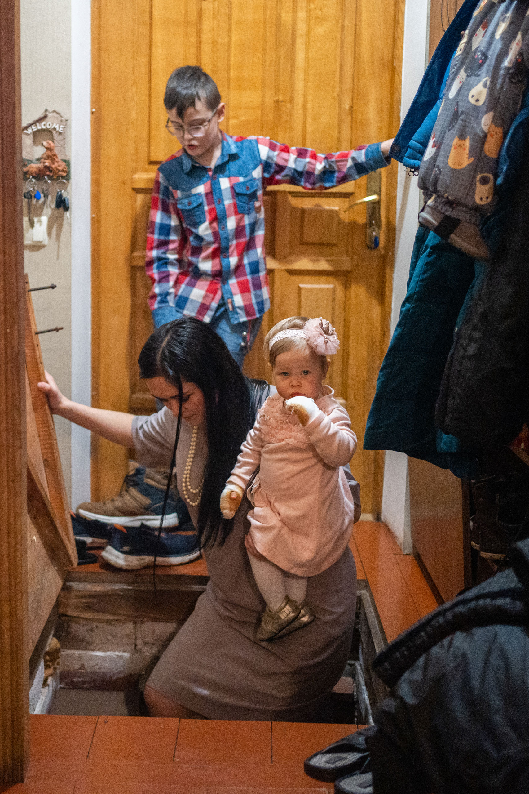 Nina and her children enter the family's basement where they have sheltered from bombing