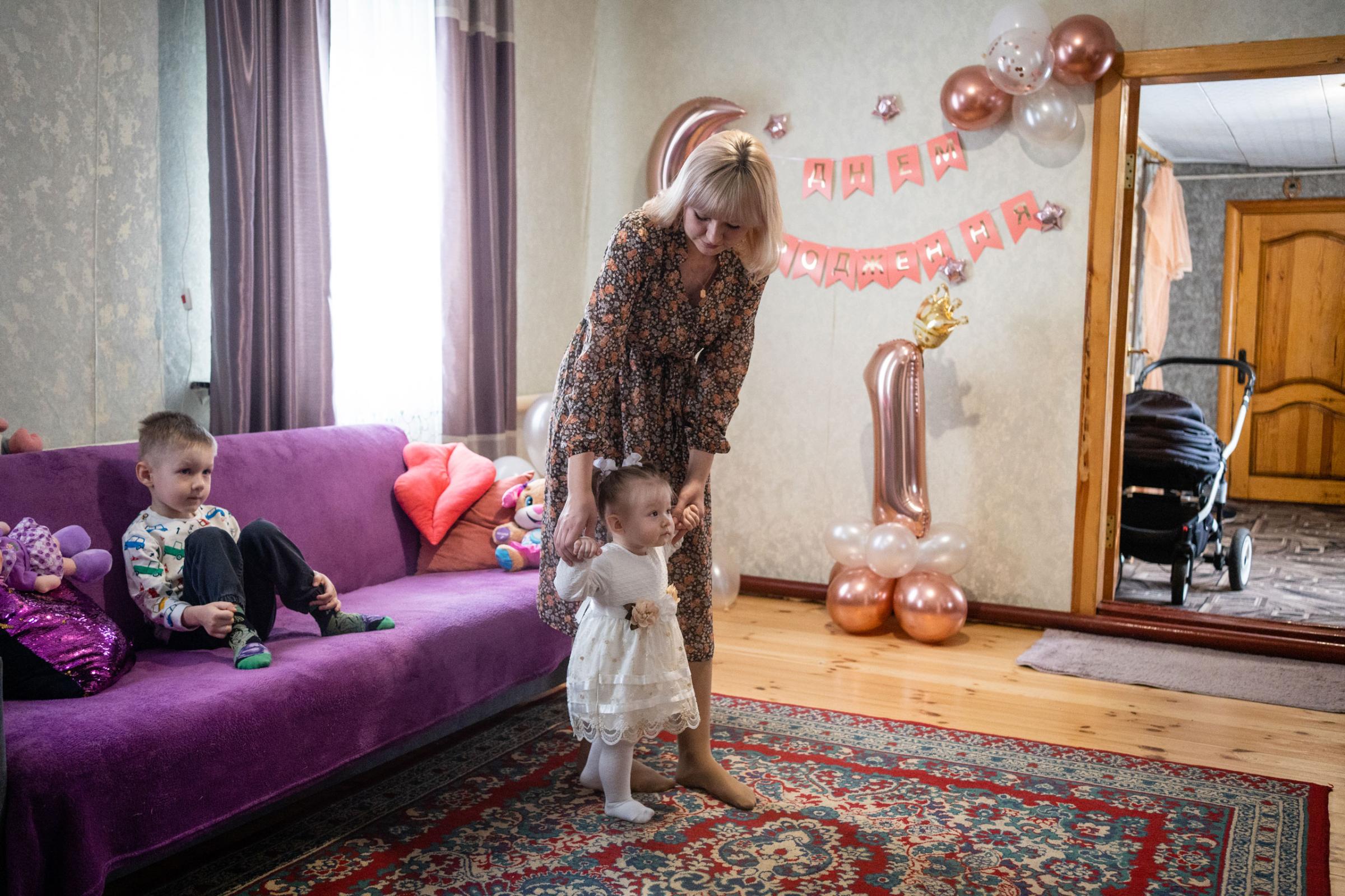 Kateryna with her two children on her daughter's 1st birthday