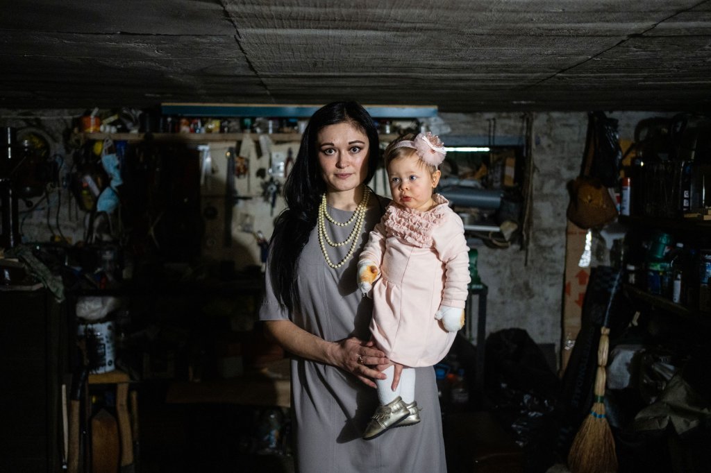 Nina with her daughter in the basement where the family have sheltered from bombing