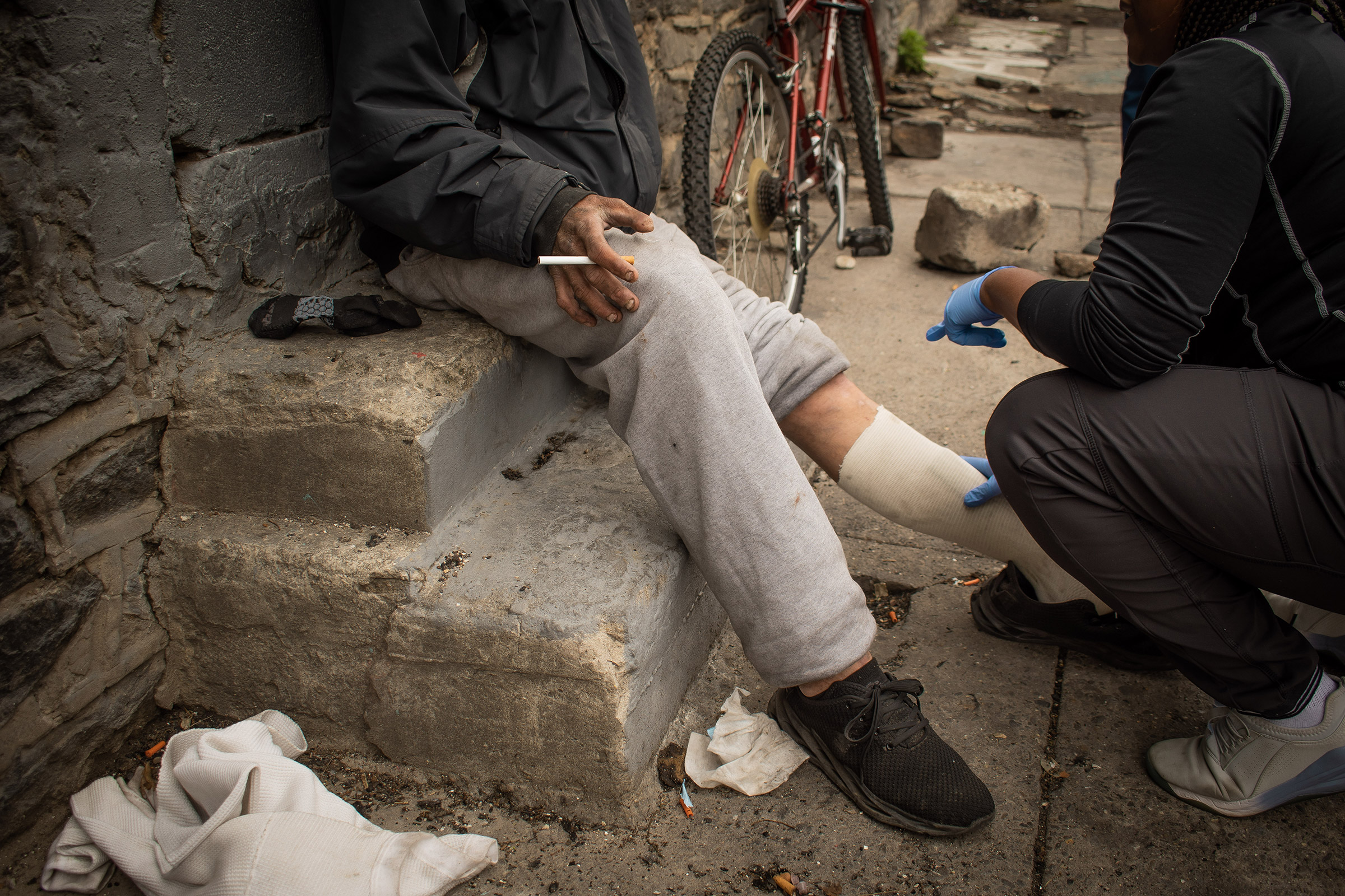 Lydia Williams, a certified wound care nurse, rebinds a patient's wounds during her shift offering street-side medical services throughout Kensington in Philadelphia, on April 19, 2023. (Anisha Kohli for TIME)