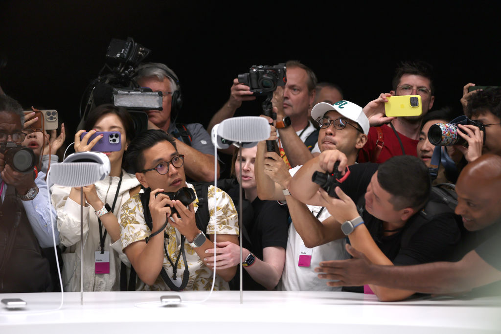 Members of the media inspect the new Apple Vision Pro headset during the Apple Worldwide Developers Conference on June 05, 2023 in Cupertino, California. Apple CEO Tim Cook kicked off the annual WWDC22 developer conference with the announcement of the new Apple Vision Pro mixed reality headset. (Justin Sullivan—Getty Images)