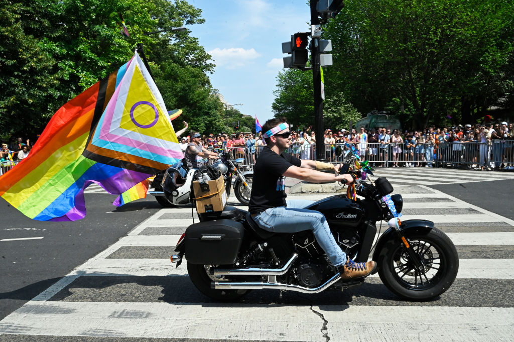 A motorcyclist flies the Intersex LGBTQIA+ Progress flag from their bike at the Capital Pride 2023 parade on June 10, 2023 in Washington, DC. (Shannon Finney—Getty Images)