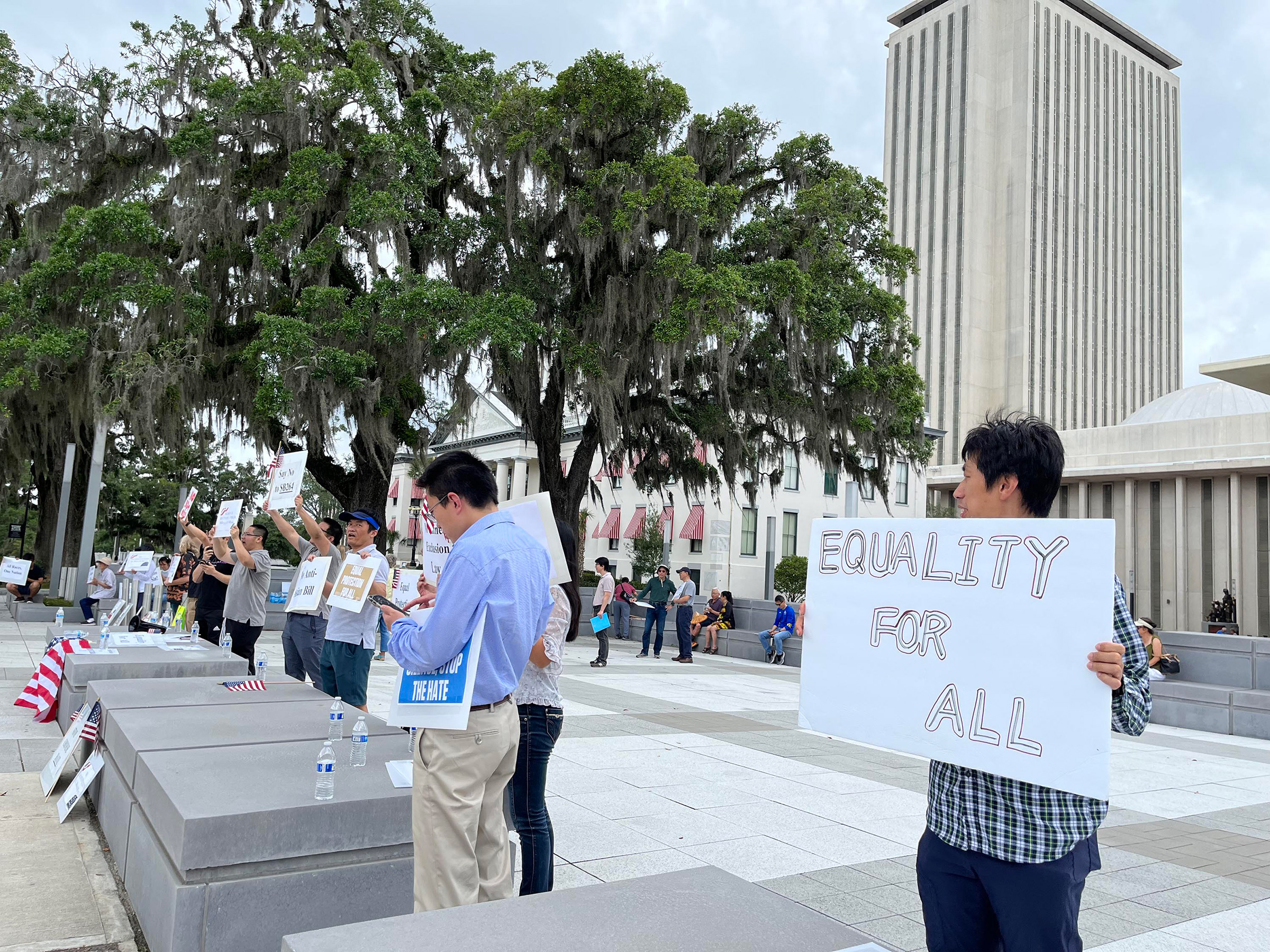 Protesters stand outside Florida's Capitol on April 29, in opposition to a bill that would ban Chinese people who are not U.S. citizens or permanent residents from owning any land or property in the state. (Lawrence Mower—Tampa Bay Times/TNS/ABACA/Reuters)