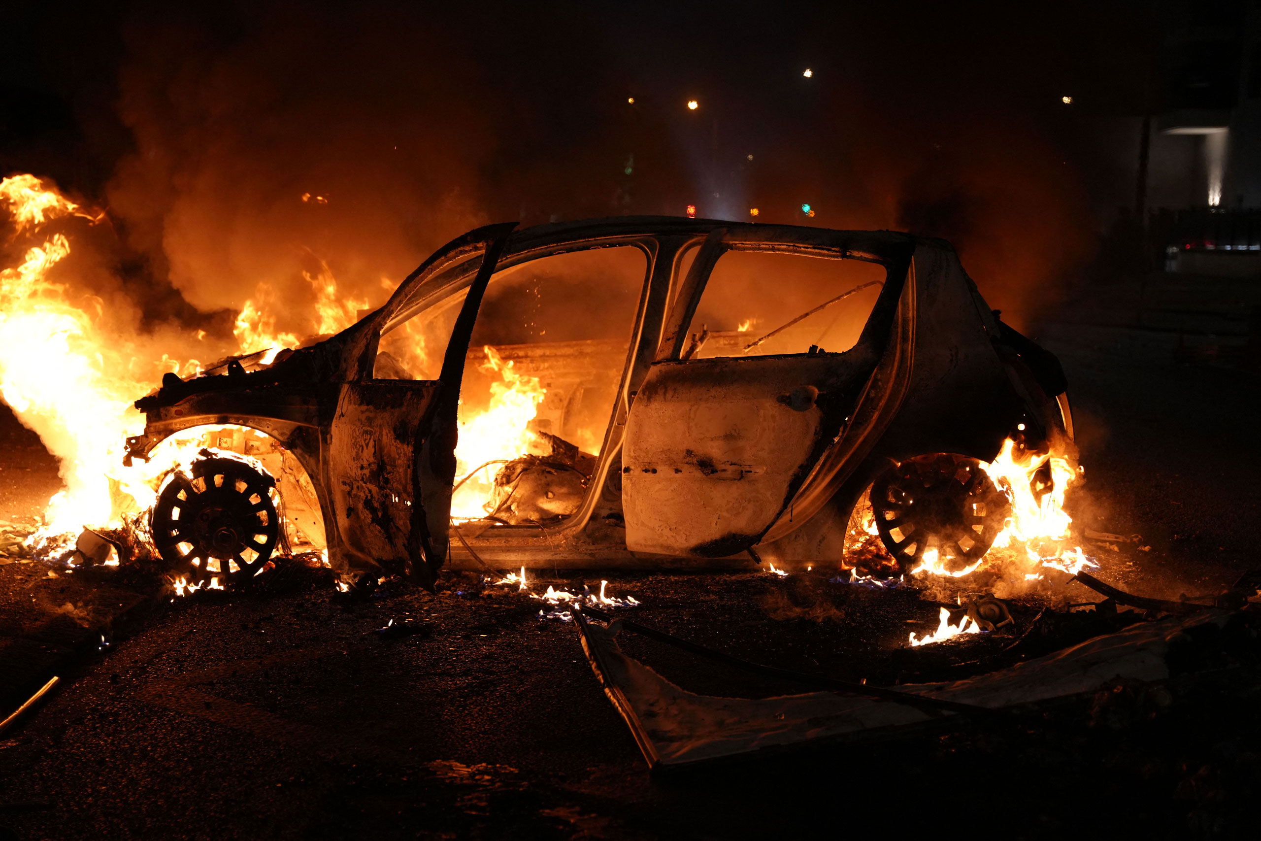 A vehicle burns during a protest in Nanterre, west of Paris, on June 27, 2023, after French police killed a teenager who refused to stop for a traffic check in the city. (Zakaria Abdelkafi—AFP/Getty Images)
