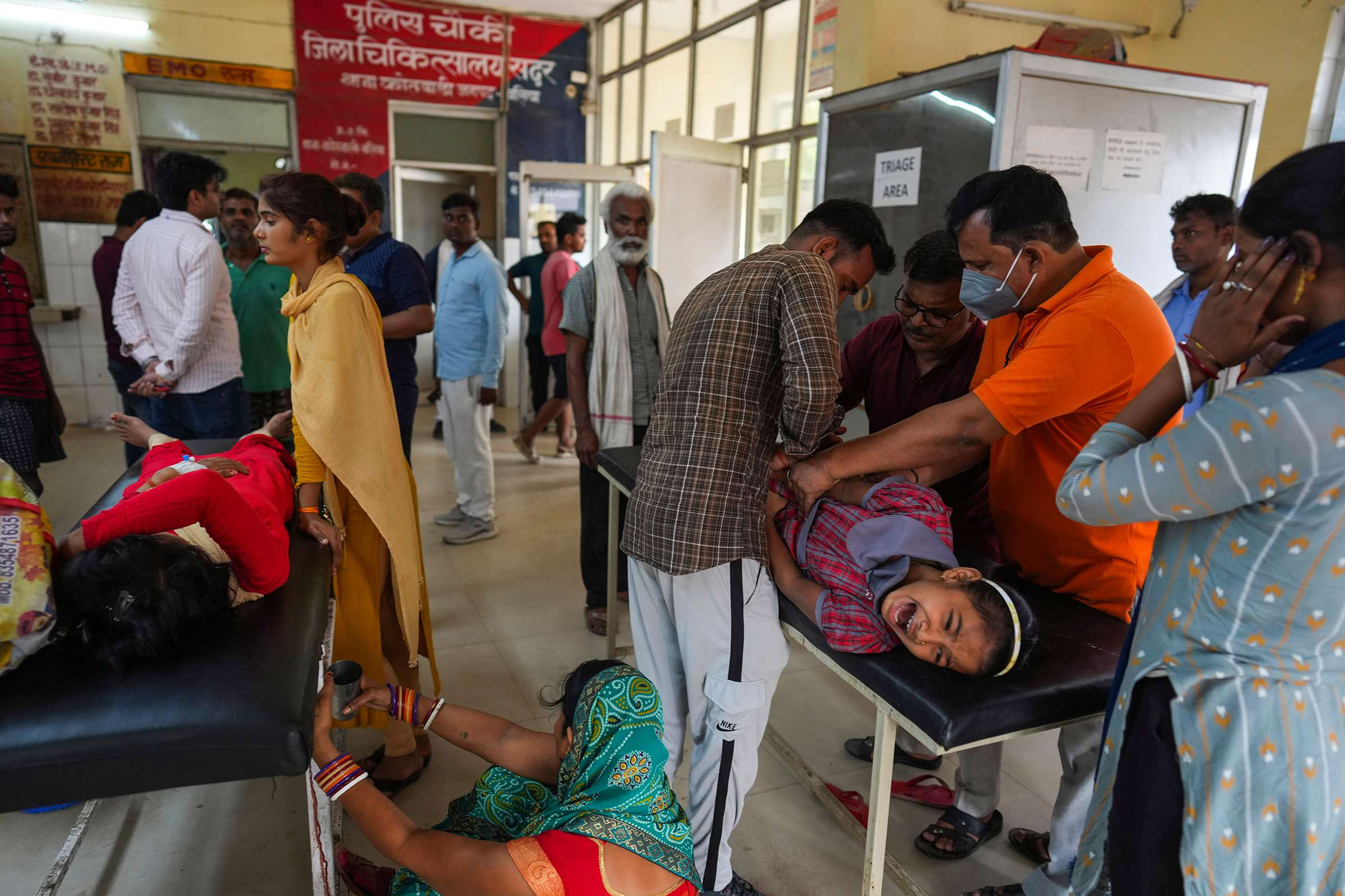 People suffering from heat related ailments crowd the district hospital in Ballia, Uttar Pradesh, India, on June 20. A scorching heat wave in two of India’s most populous states has overwhelmed hospitals, filled a morgue to capacity and disrupted power supply, forcing staff to use books to cool patients as officials investigate the climbing death toll. (Rajesh Kumar Singh—AP)