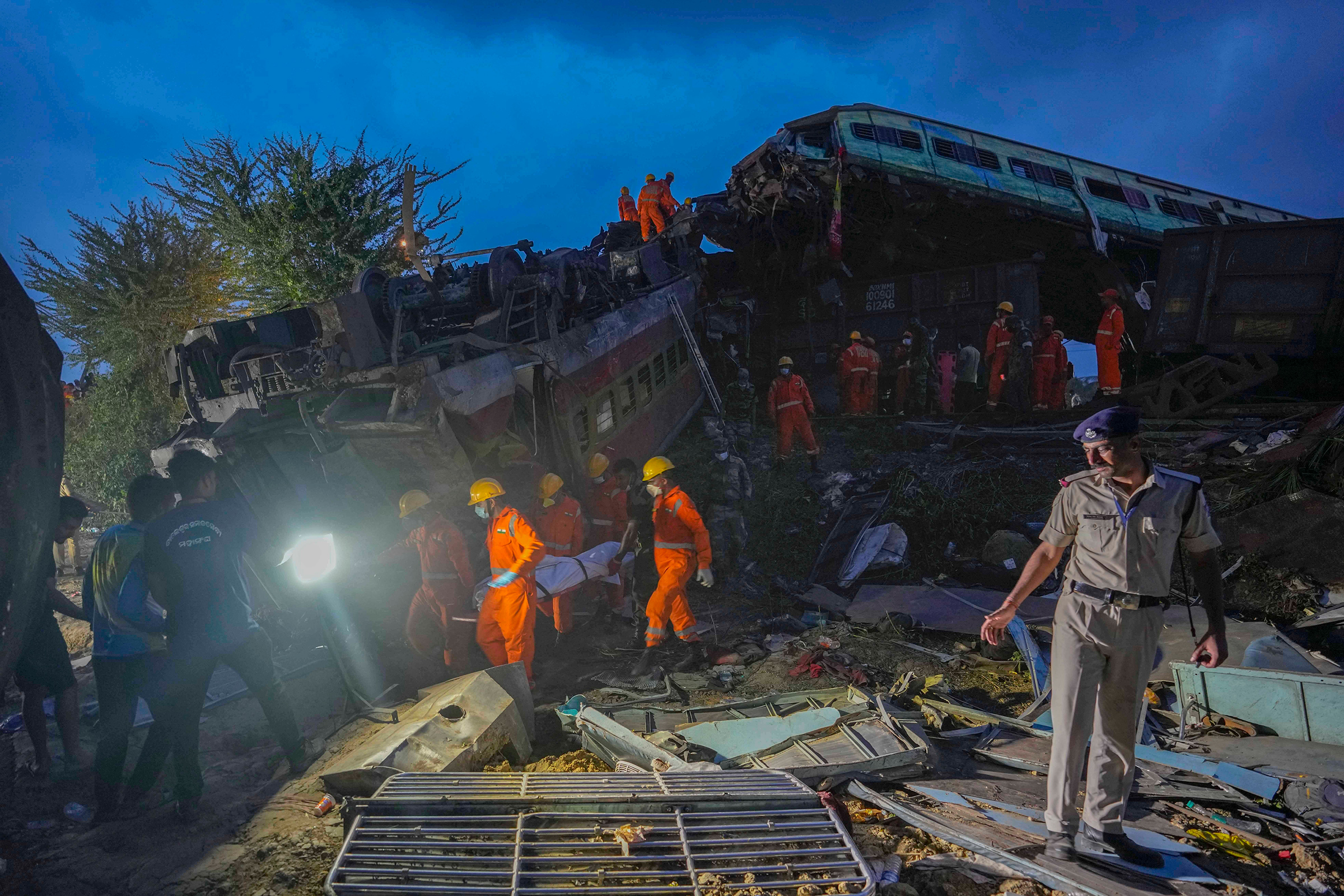 Rescuers carry the body of a victim at the site of passenger trains that derailed in Balasore, in the eastern Indian state of Orissa, India, on June 3. (Rafiq Maqbool—AP)