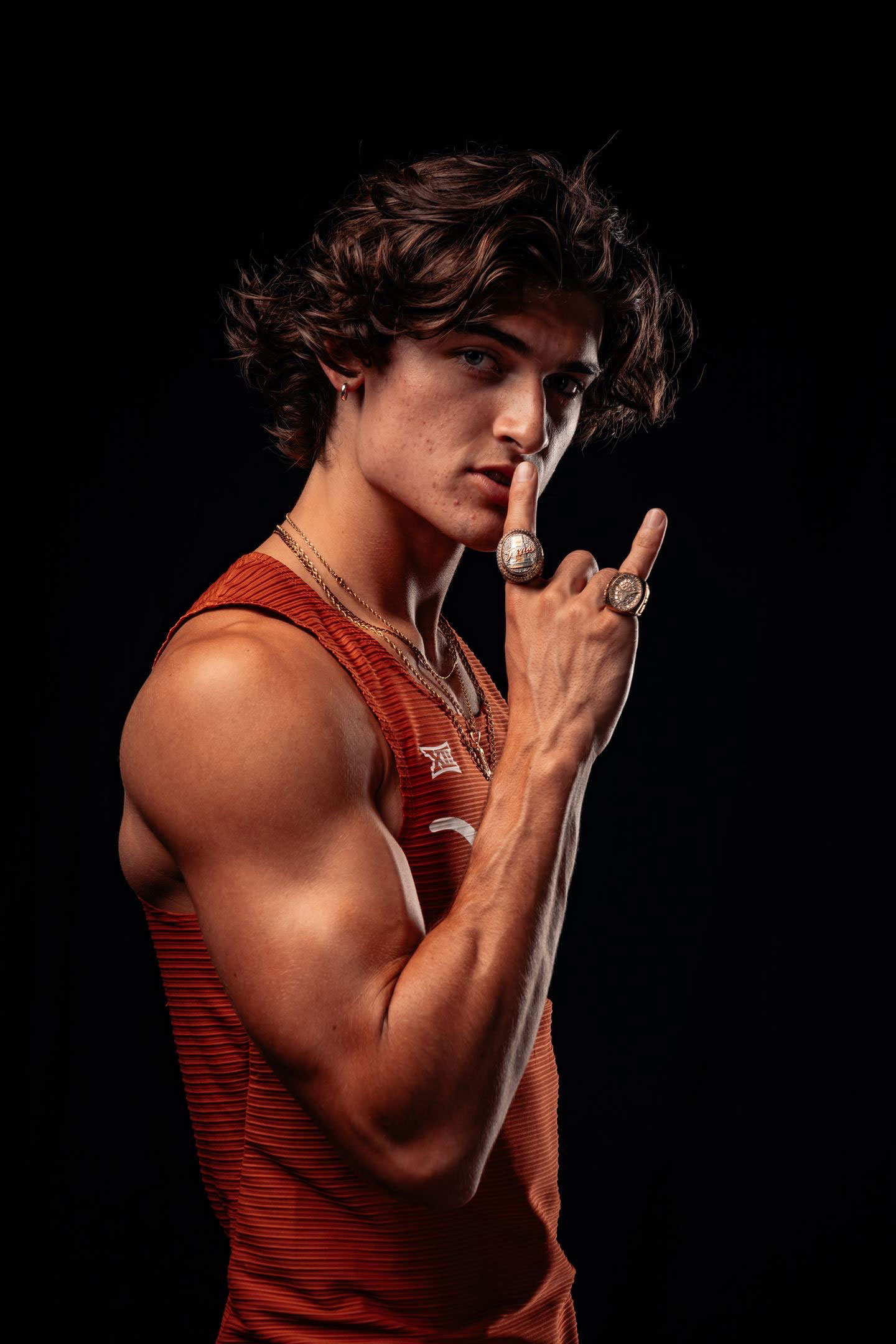 College athlete and influencer Sam Hurley wearing two championship rings for the University of Texas’ track and field team