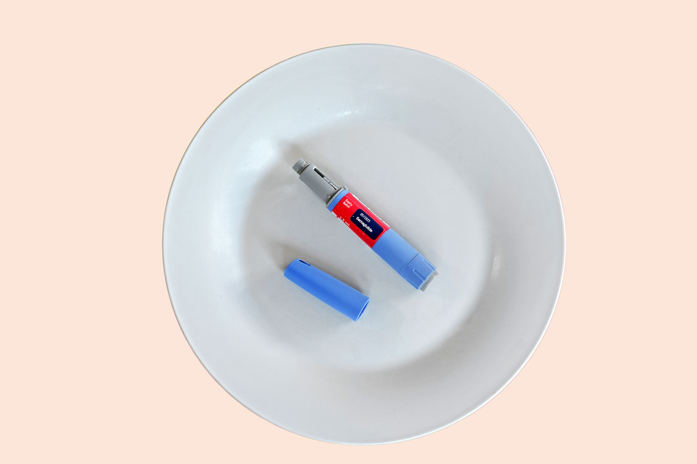 Semaglutide injecting  pen with lid on a white plate. (Getty Images)