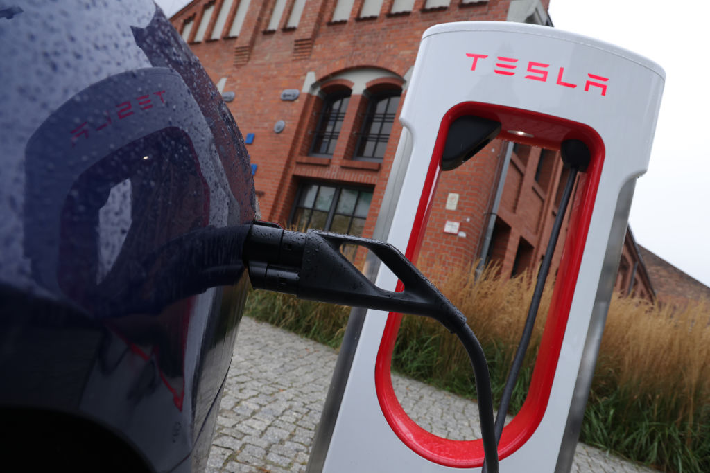 A Tesla electric car charges at a Tesla charging station in Berlin (Sean Gallup/Getty Images)