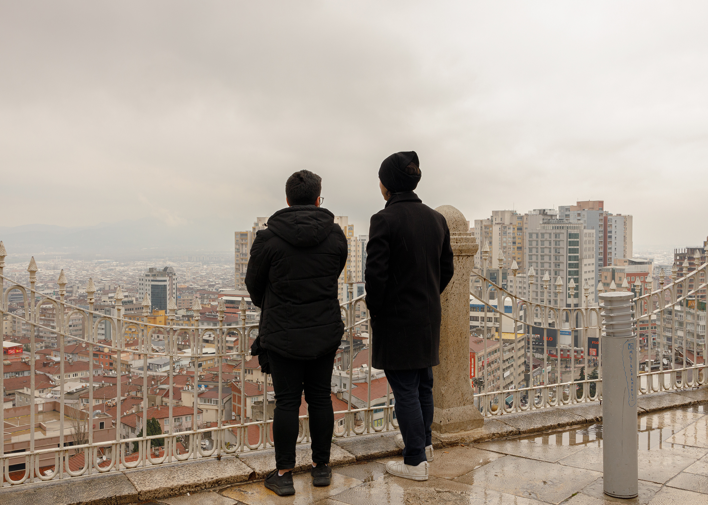 Mehdi*, 23, and Samir*, 24, originally from Aleppo and based in Gaziantep, Turkey, look out at Bursa, a city close to Istanbul where the two brothers found refuge after the Turkish government granted 60-days travel permission to Syrians under temporary protection, in April. (Their names have been changed.) The $500 provided by the government to all affected families also helped Mehdi and Samir to temporarily move away from their adopted city, while the aftershocks continued. (Carola Cappellari)