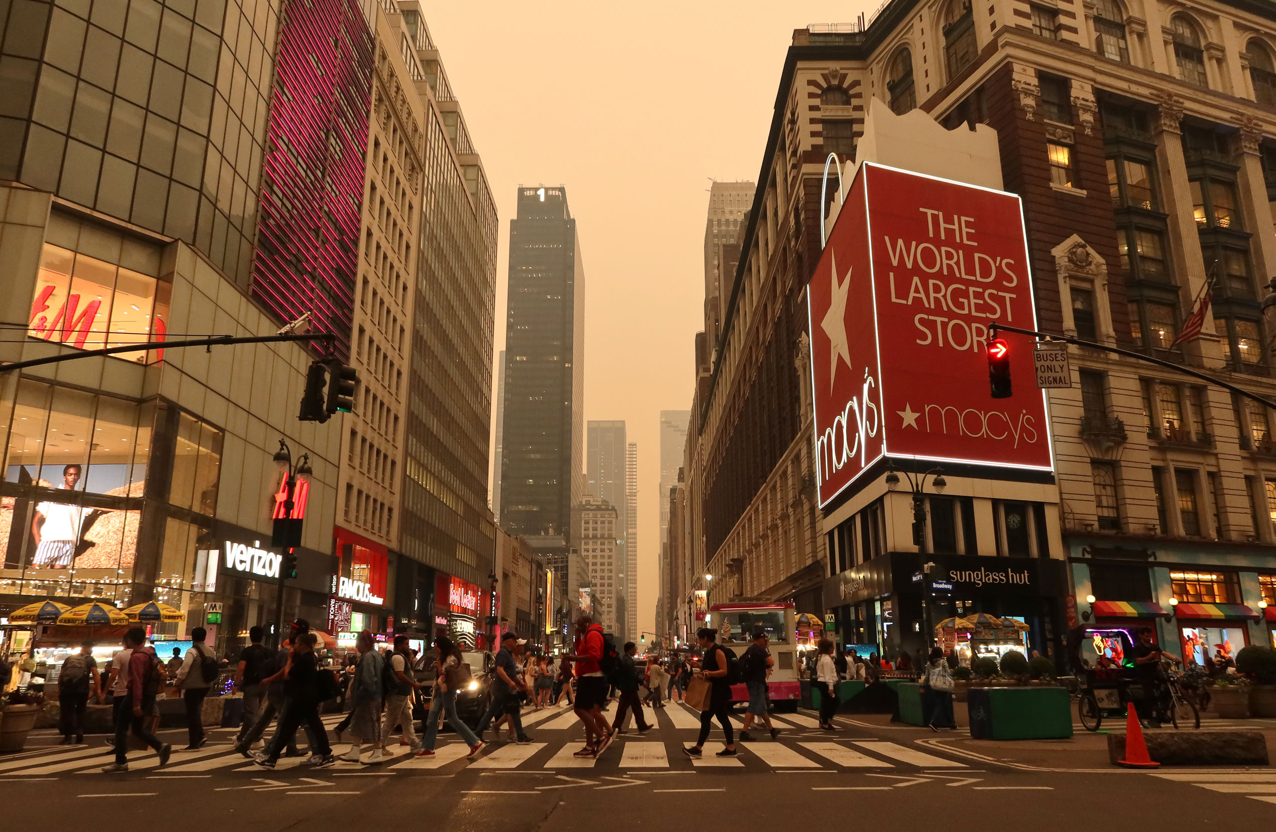 Heavy smoke fills the air as people cross 34th Street in Herald Square in New York City on June 6, 2023. (Gary Hershorn—Getty Images)