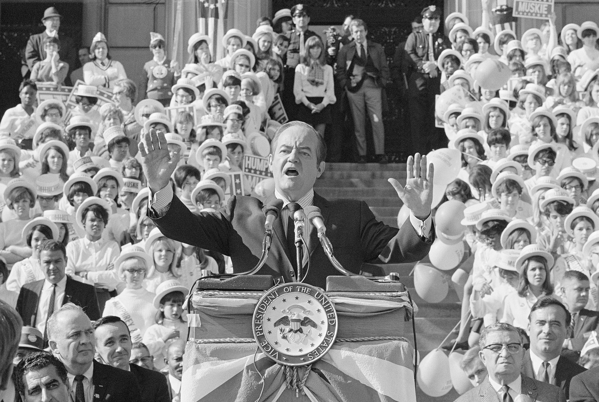 Hubert Humphrey Speaking at Podium with a crowd behind him