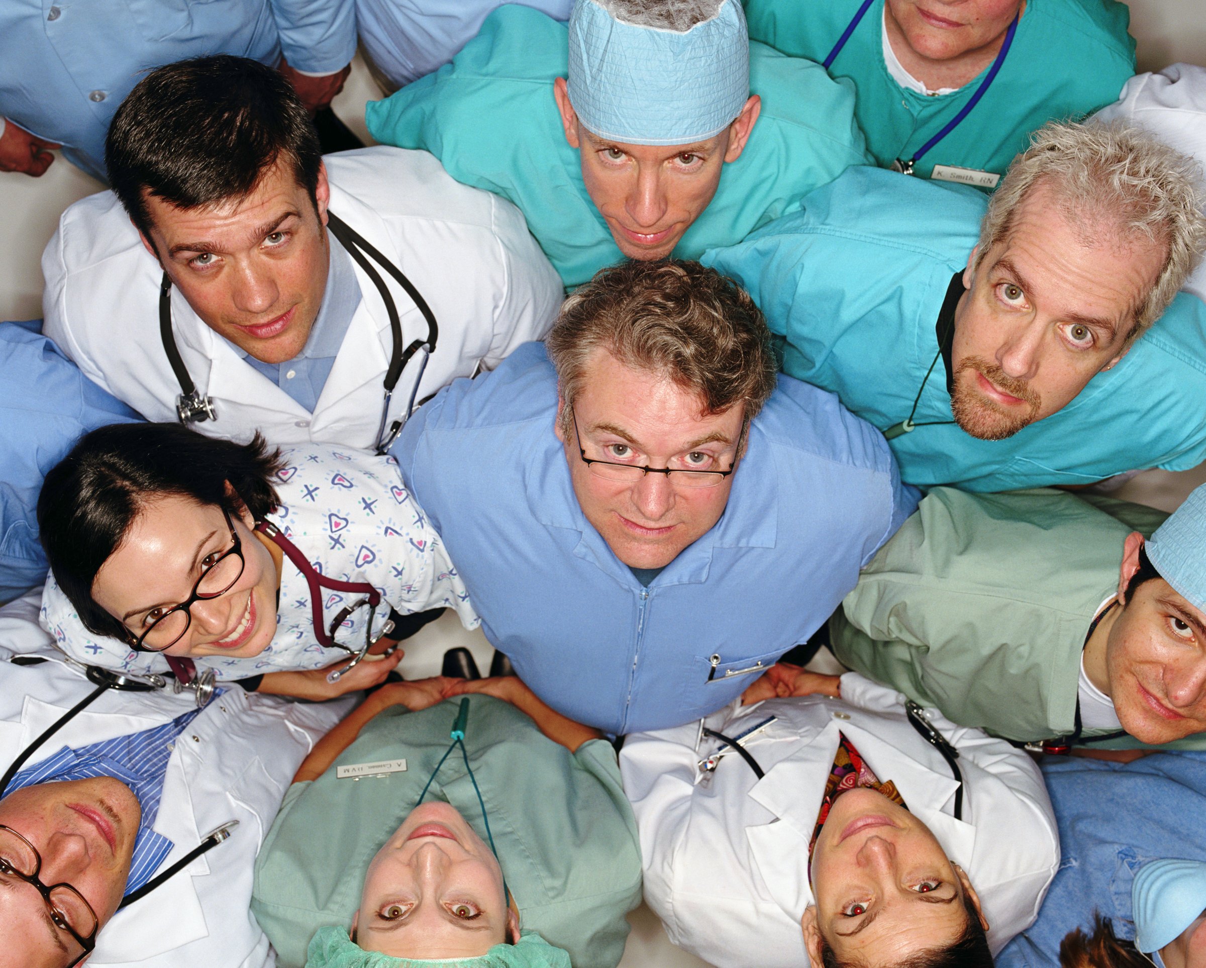 Group of healthcare professionals looking up, overhead view
