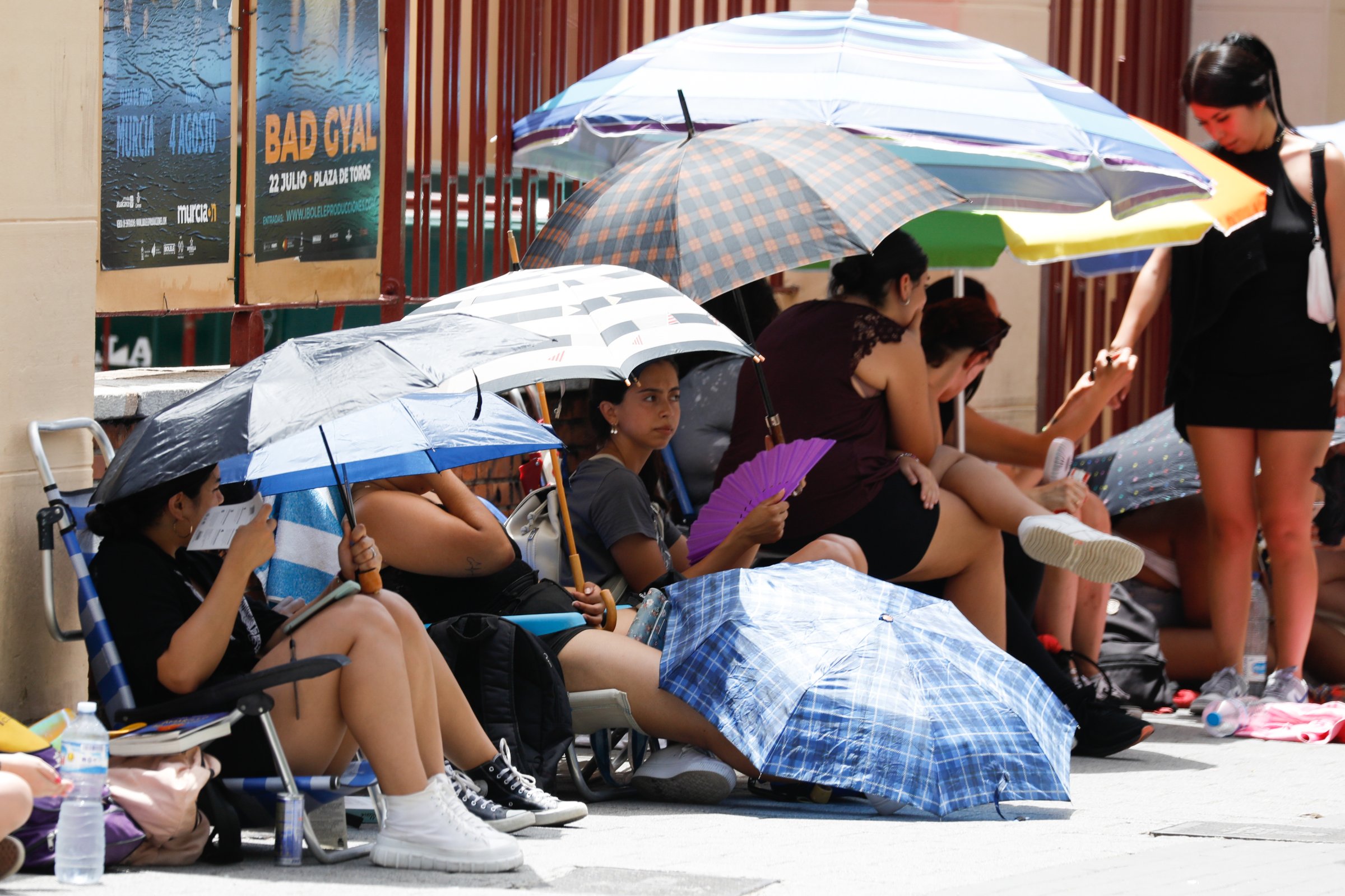 People take shelter from the heat under umbrellas, in Murcia, Spain.