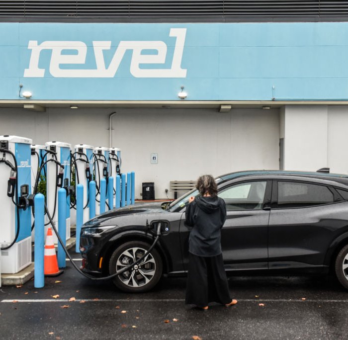 A driver charges an electric vehicle at the Revel charging station on Marcy Avenue in the Bedford-Stuyvesant neighborhood in the Brooklyn borough of New York, U.S., on Oct. 24, 2022.