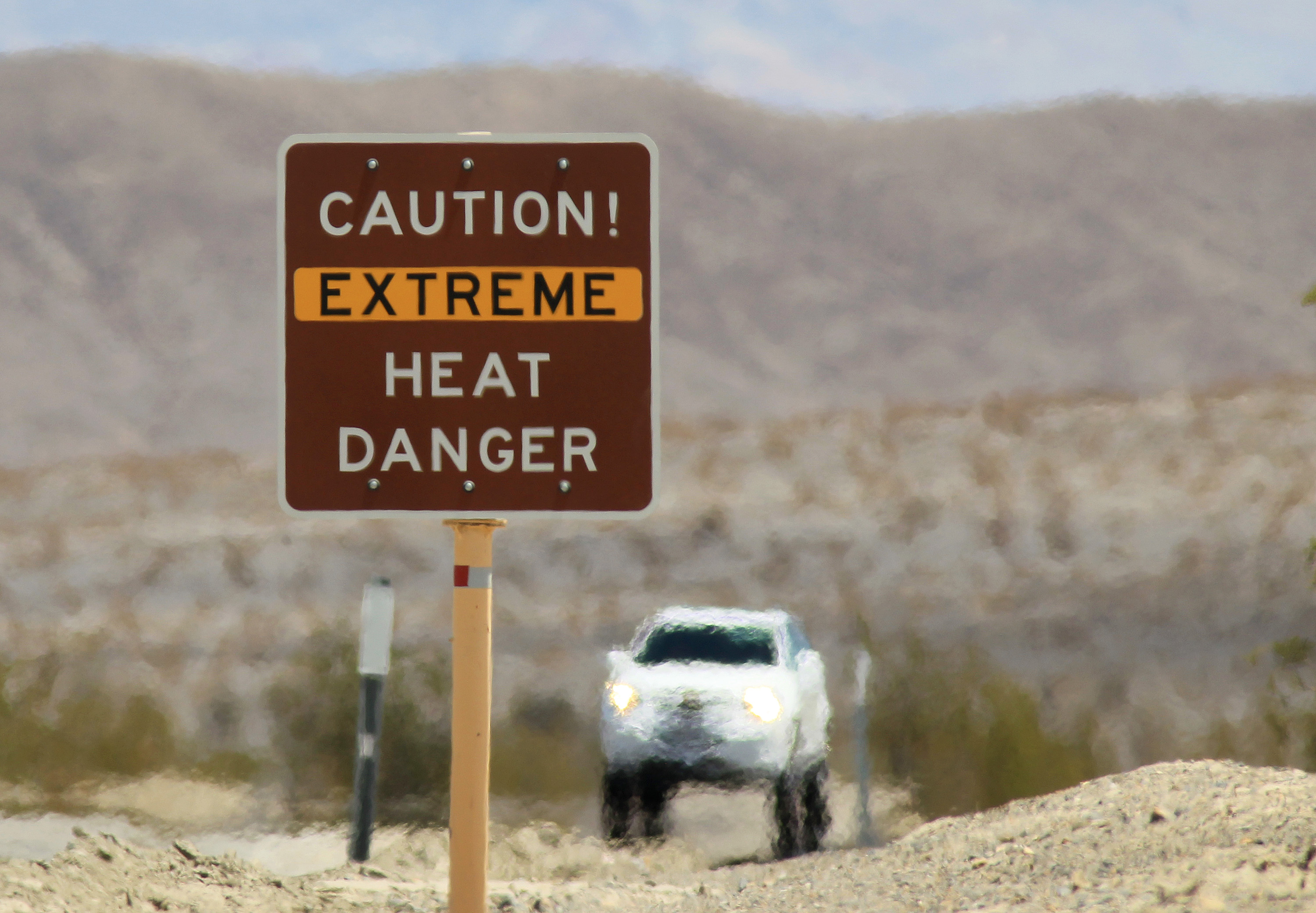 DEATH VALLEY NATIONAL PARK, CA JULY 14:  Heat waves rise near a heat danger warning sign on the eve of the AdventurCORPS Badwater 135 ultra-marathon race in Death Valley, California. (Getty Images;2013 Getty Images)
