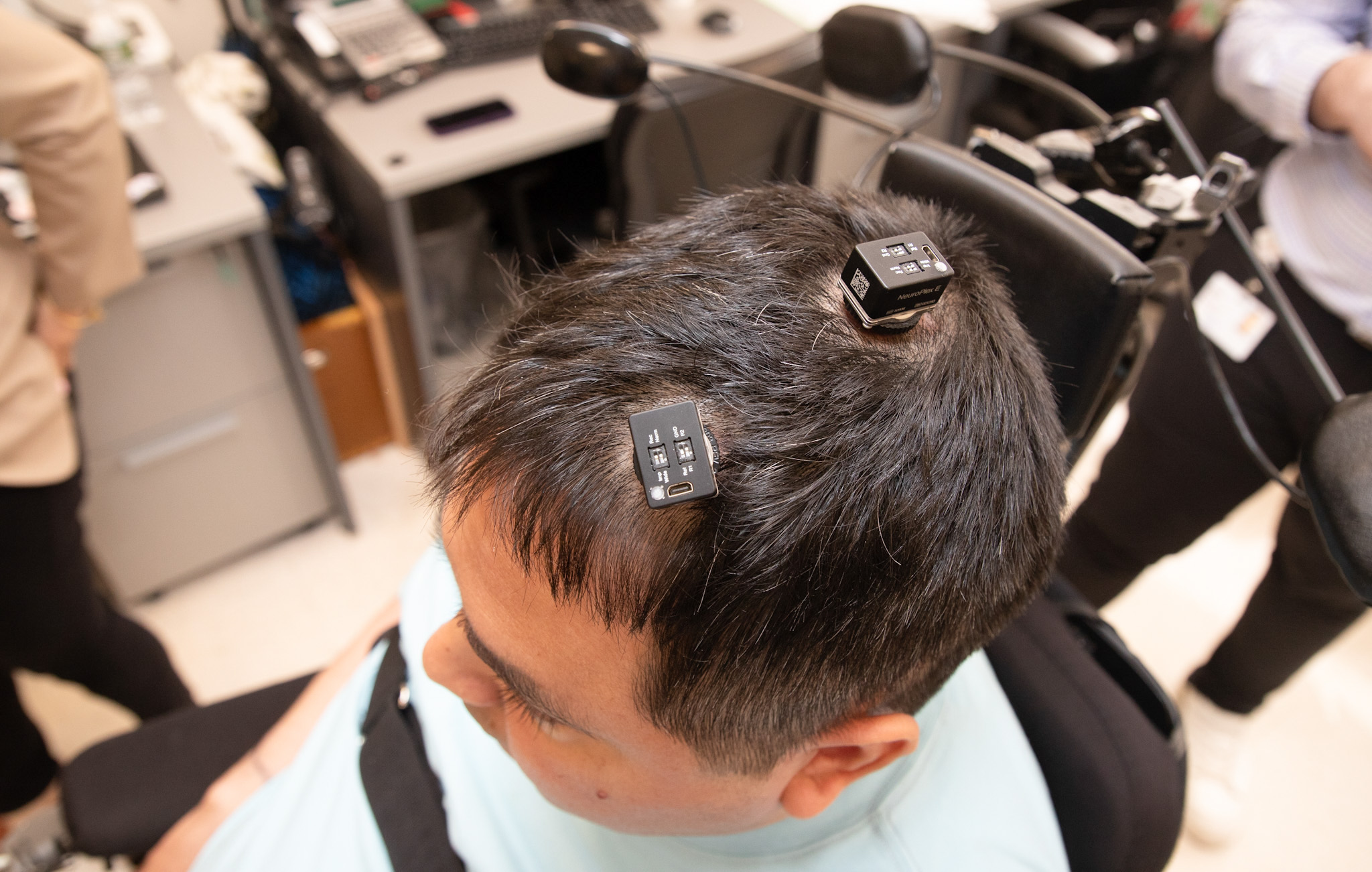 Keith Thomas, who lives with paralysis, had five tiny electrode arrays implanted in his brain in a novel technique known as double neural bypass. When connected to a computer, the chips use artificial intelligence to decode and translate his thoughts into action. (Courtesy Feinstein Institutes for Medical Research)