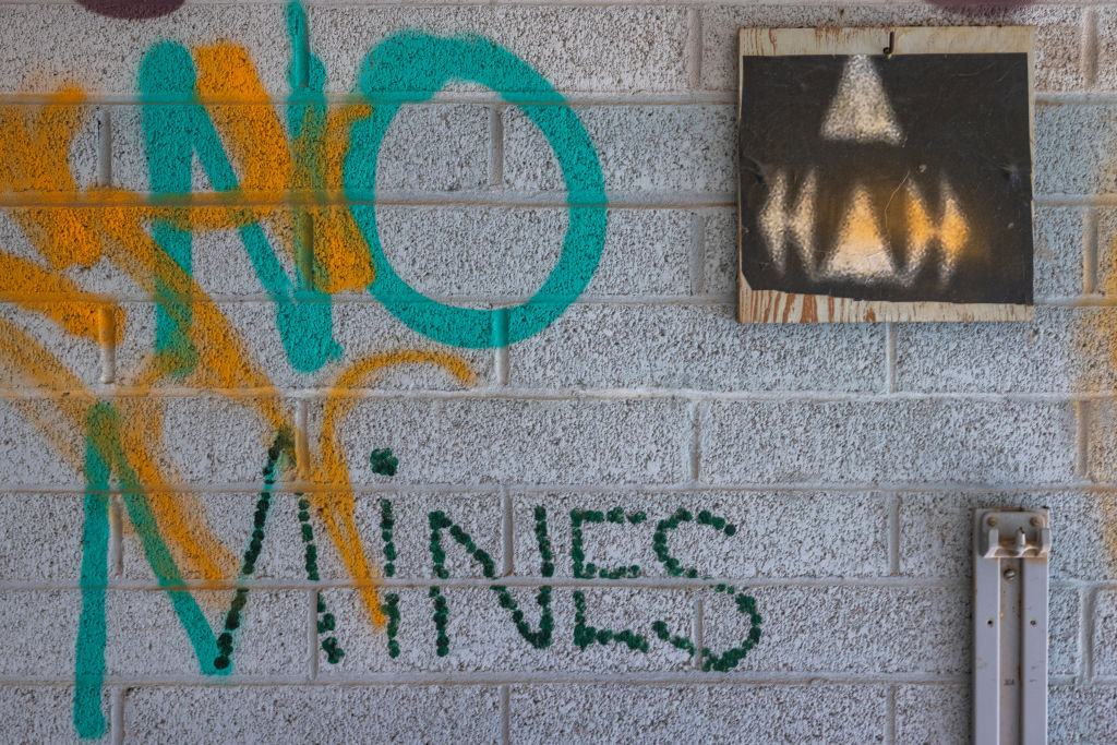 Graffiti opposing mines on the reservation is seen in an abandoned building on Sept. 12, 2022 on the Navajo Nation west of Tuba City, Arizona. (David McNew—Getty Images)