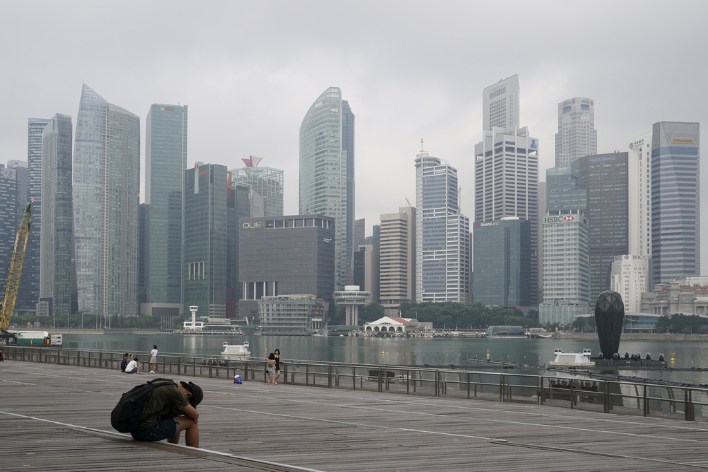 A man takes a nap in Singapore's central business district on Sept. 23, 2019. (Vincent Thian—AP)
