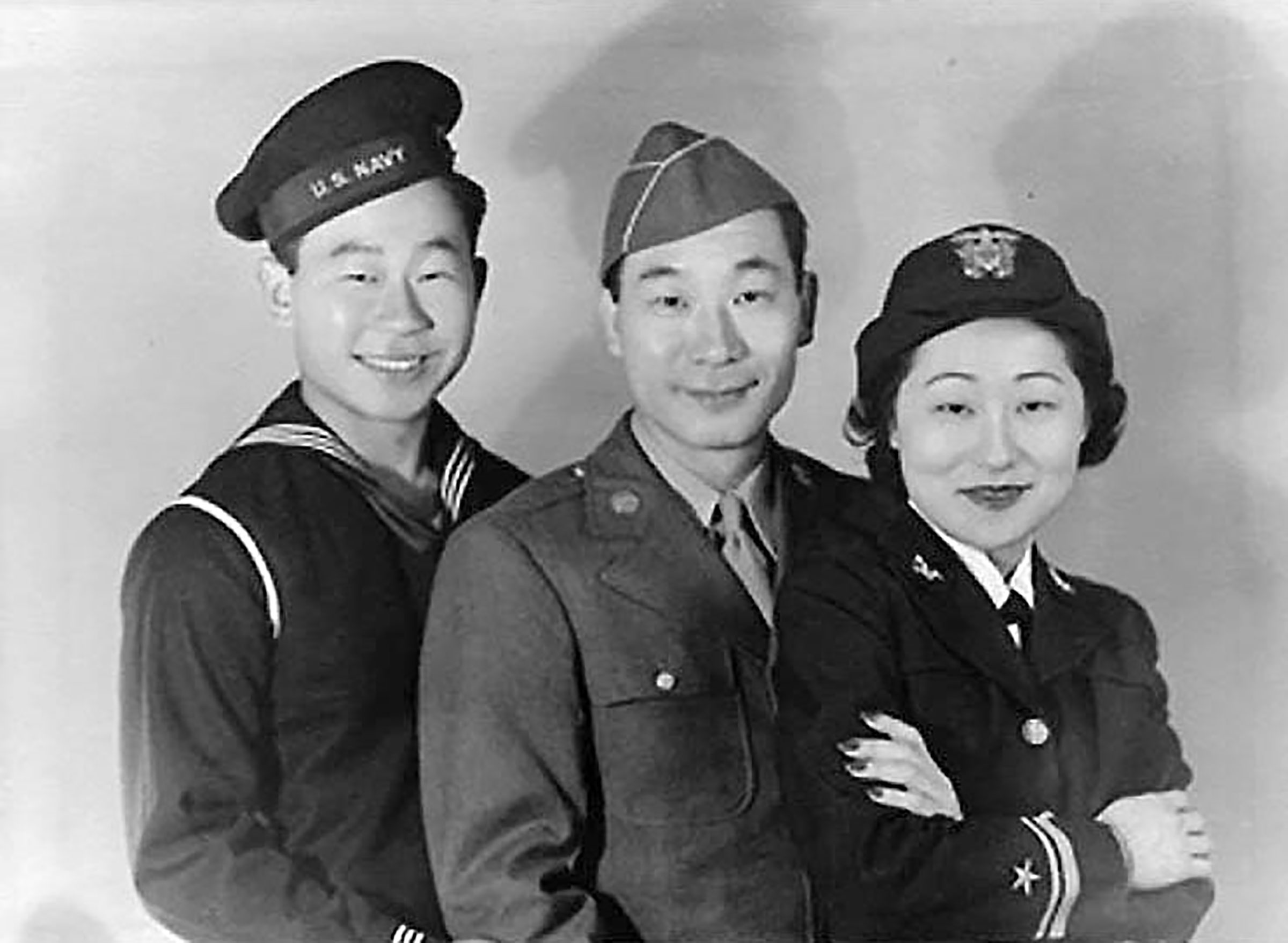 A portrait of Ralph, Philip and Susan Ahn standing in a row in uniform