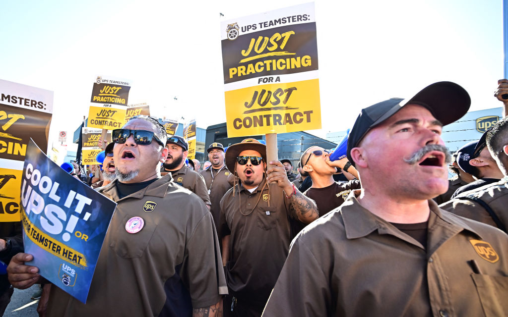 UPS workers hold placards at a rally held by the Teamsters Union on July 19, 2023 in Los Angeles, California, ahead of an August 1st deadline for an agreement on a labor contract deal and to avert a strike. (Photo by Frederic J. Brown—AFP/Getty Images)
