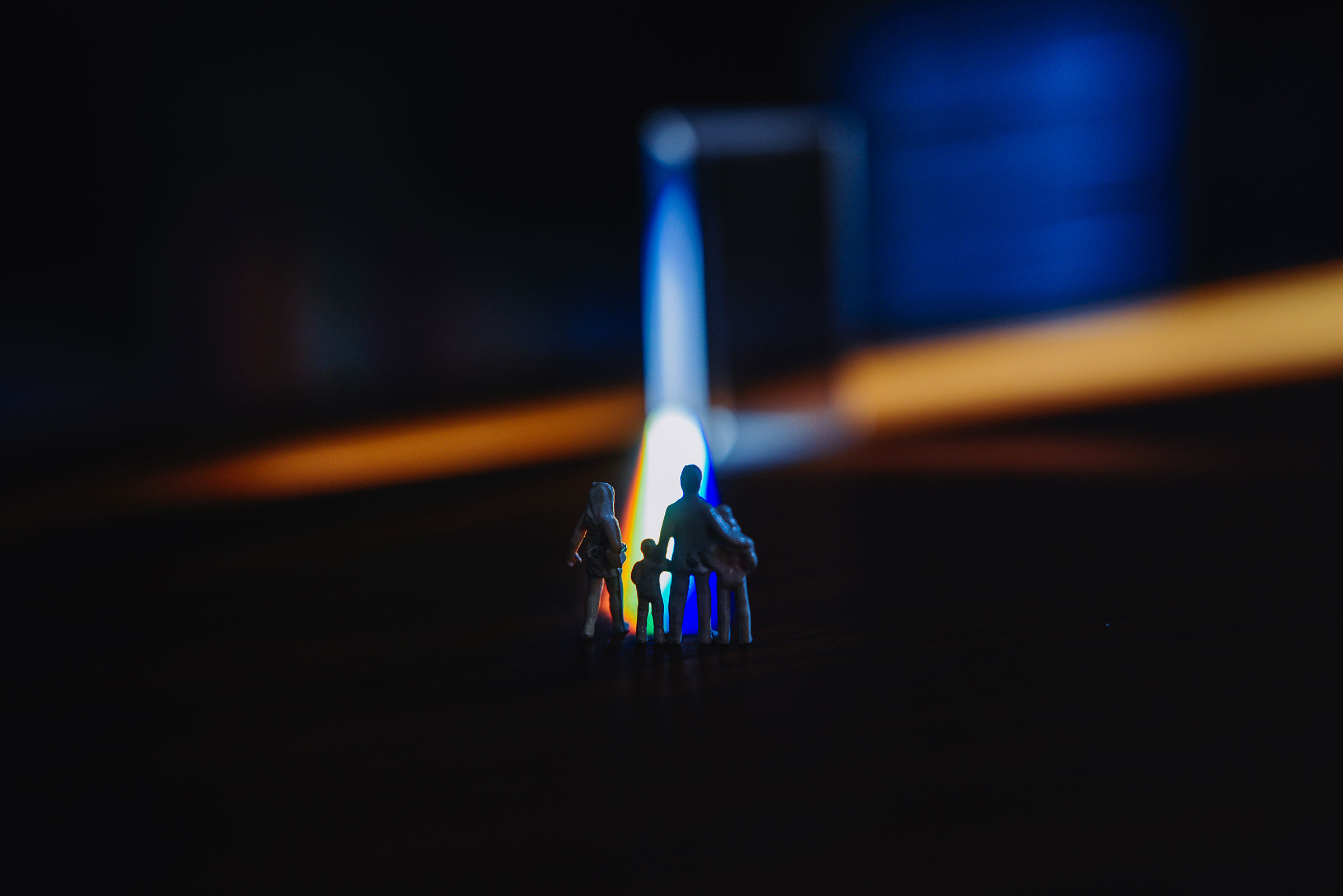 Plastic figurines standing in of light beam.