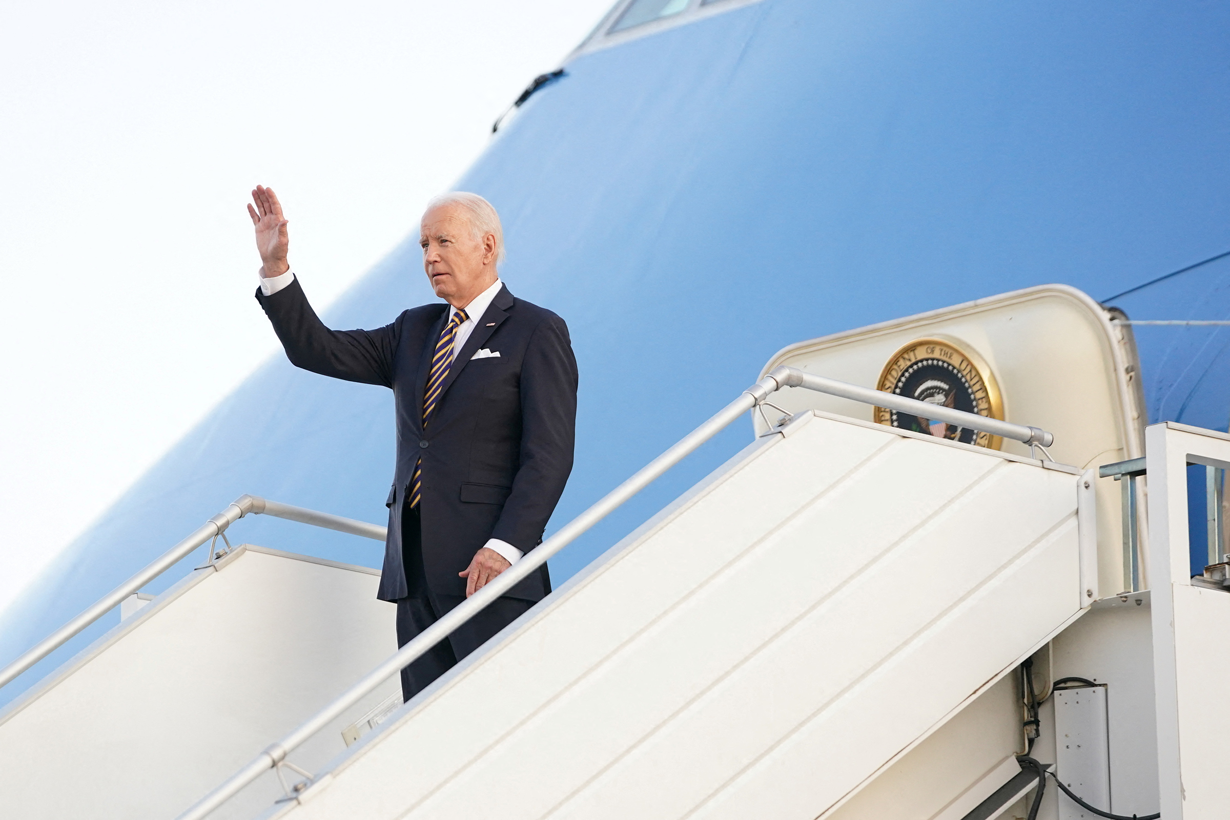 U.S. President Joe Biden waves upon arrival in Helsinki, Finland, on July 12. (Kevin Lamarque—Reuters)