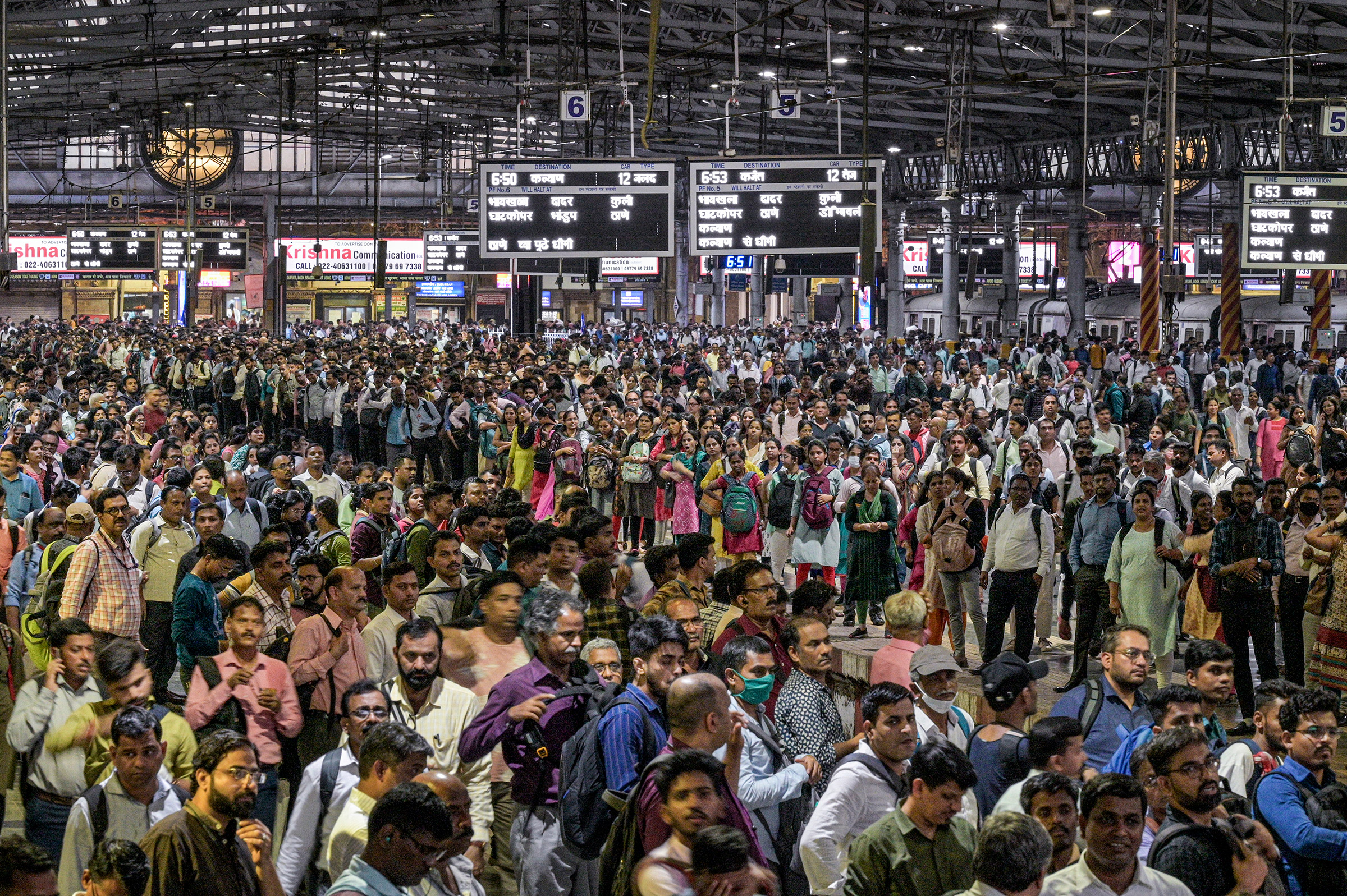 Daily commuters wait for the suburban train on the platform of CST station in Mumbai on April 17.