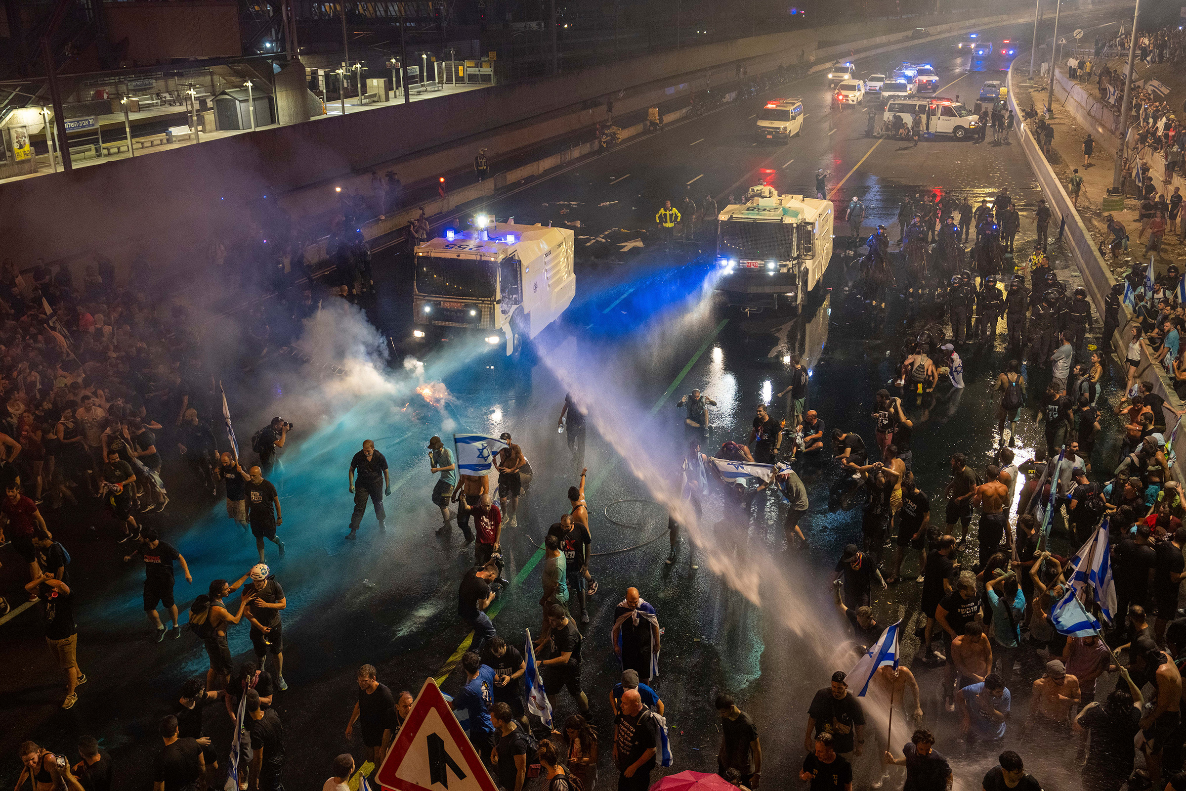 Riot police tries to clear demonstrators with a water canon during a protest against plans by Netanyahu's government to overhaul the judicial system, in Tel Aviv on July 24. Israeli lawmakers on Monday approved a key portion of Prime Minister Benjamin Netanyahu's divisive plan to reshape the country's justice system despite massive protests that have exposed unprecedented fissures in Israeli society.