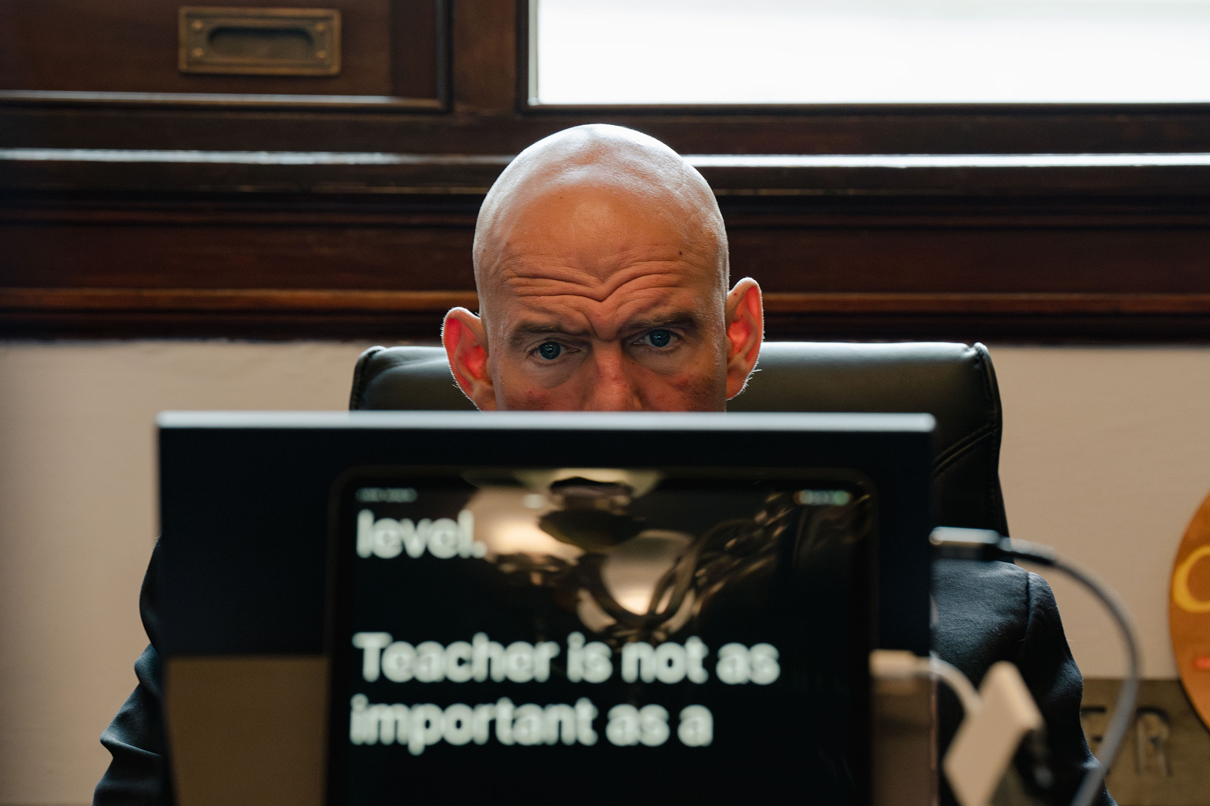 Fetterman reads closed captions on his device during a May 16 meeting (Shuran Huang for TIME)