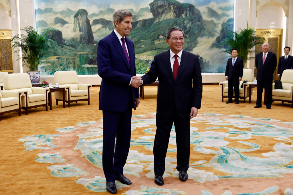 U.S. climate envoy John Kerry (L) is greeted by Chinese Premier Li Qiang before a meeting in the Great Hall of the People on July 18, 2023 in Beijing, China. Kerry is in Beijing to restart climate negotiations between the world's two biggest polluters.